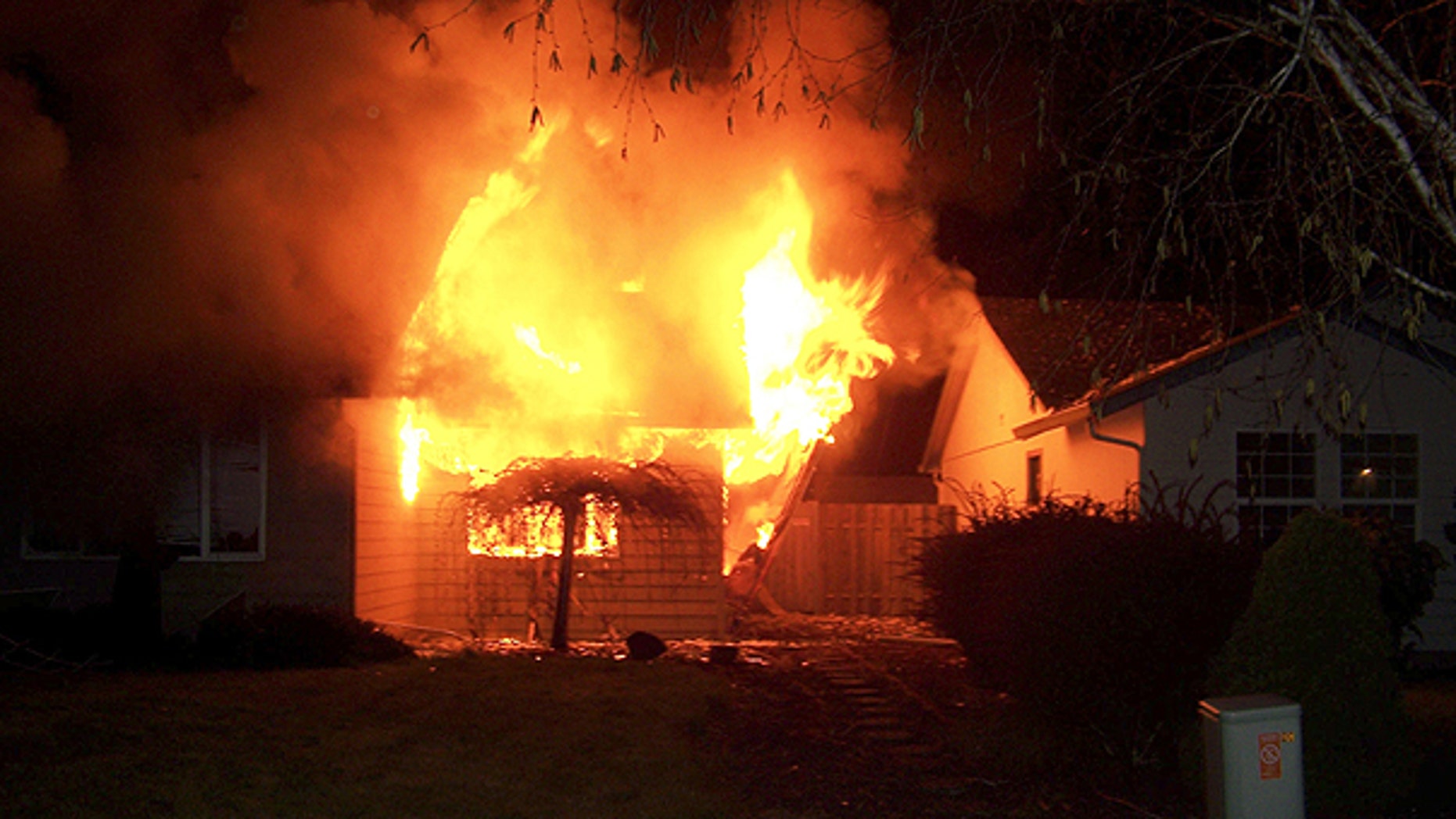 April 24: In this photo provided by Kathy Larsen via The Columbian, flames engulf a house in Vancouver, Wash.