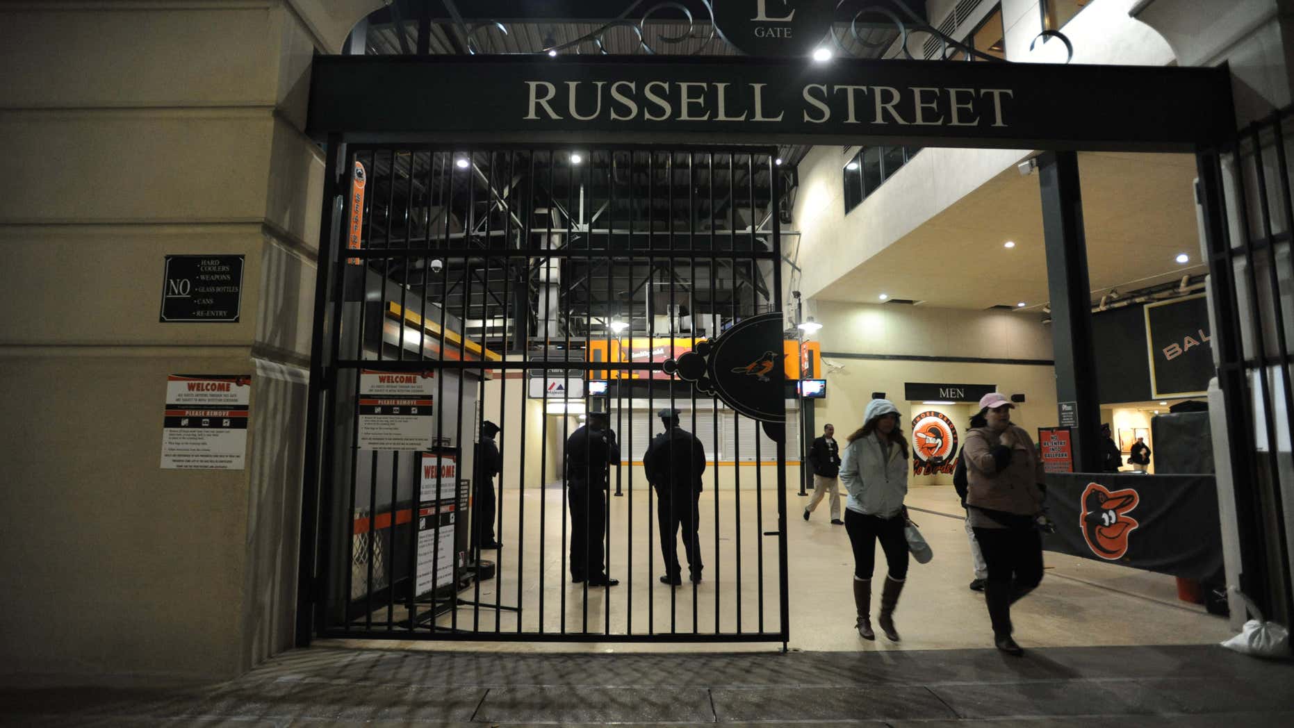 April 25, 2015: Baltimore city police officers stand at the Russell Street exit after allowing fans to leave the Orioles Boston and the Boston Red Sox baseball game.