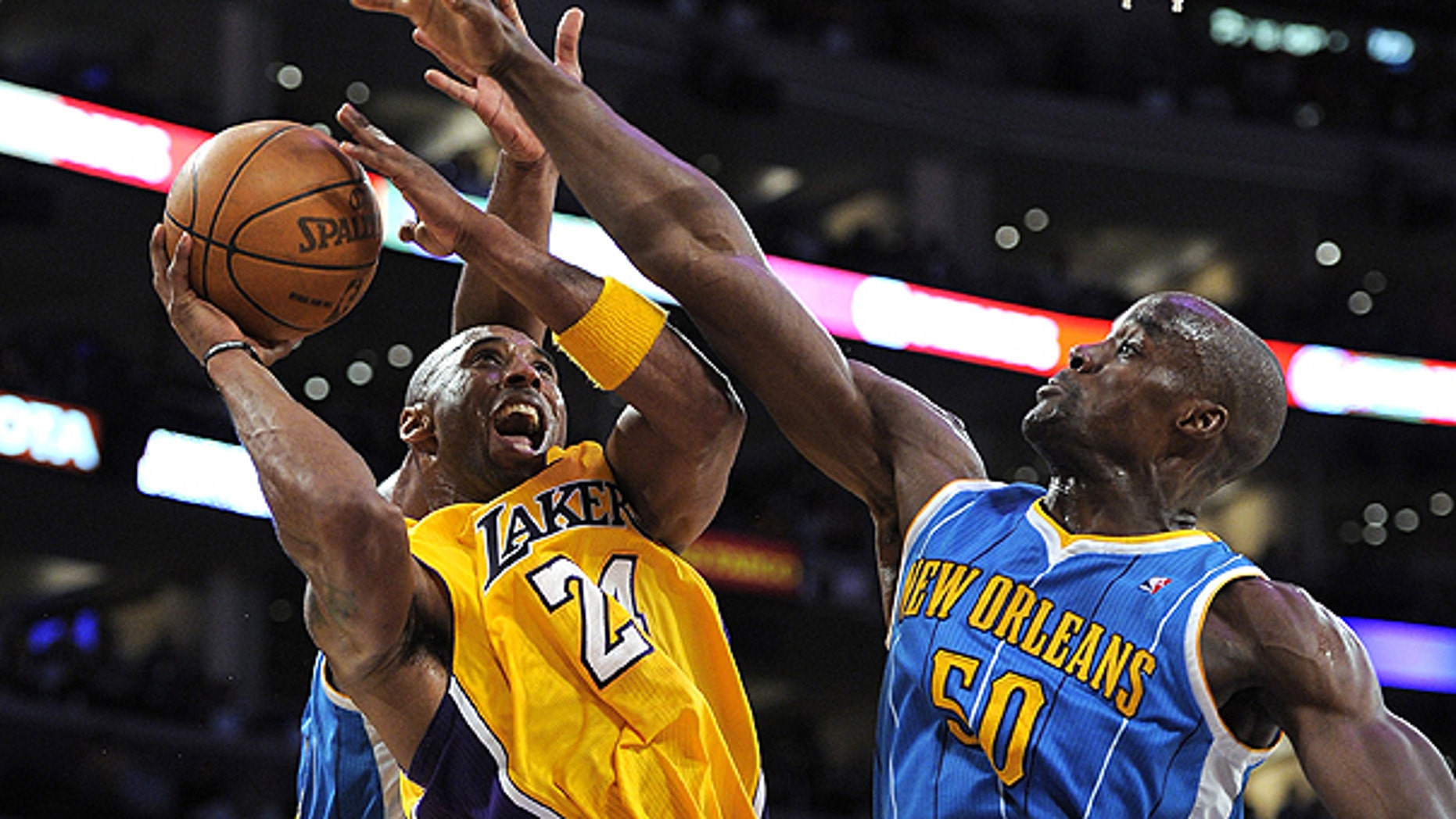 April 26: Los Angeles Lakers guard Kobe Bryant, left, goes up for a shot as New Orleans Hornets center Emeka Okafor defends during the second half in Game 5 of a first-round NBA basketball playoff series in Los Angeles.