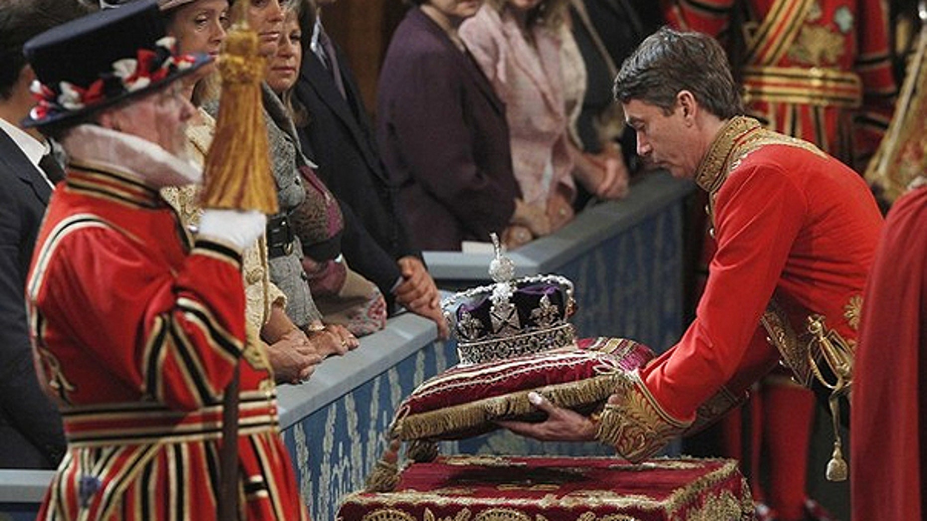 May 25, 2010: The Imperial State Crown is carried into the Royal Gallery for Britain's Queen Elizabeth during the State Opening of Parliament at the Palace of Westminster in London.