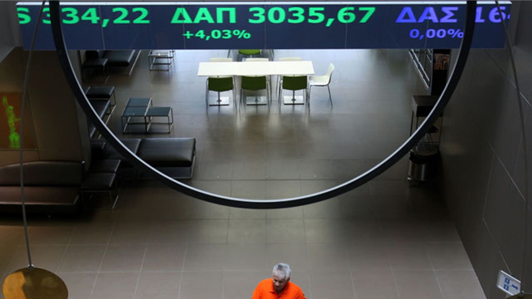 Stock price tickers flash green, indicating gains, at the Athens stock exchange on Friday, April 23, 2010. Greek Prime Minister George Papandreou called Friday for the activation of a joint eurozone-International Monetary Fund financial rescue to pull his country out of a major debt crisis.