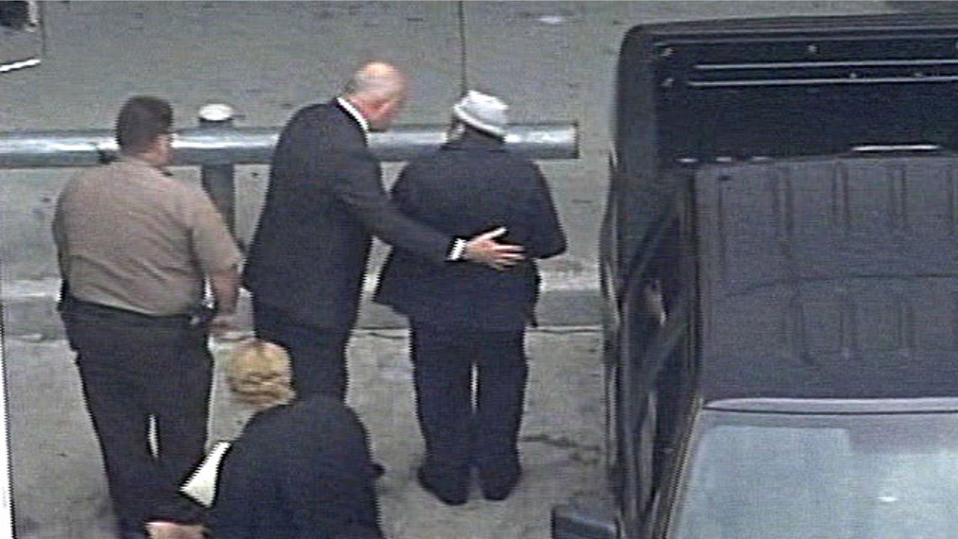 April 10, 2010: In this image from video from WSVN-TV, former Panamanian dictator Manuel Noriega, wearing hat, right, arrives at Miami International Airport in Miami to board an Air France flight to Paris.