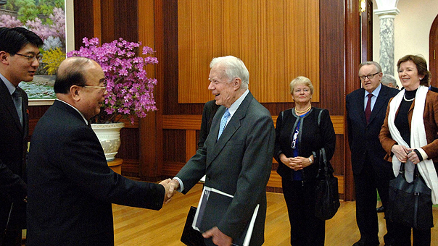 April 26: n this photo released by Korean Central News Agency via Korea News Service in Tokyo, former U.S. President Jimmy Carter, center, is greeted by Pak Ui Chun, second left, North Korea's foreign minister, in the Paekhwawon state guesthouse in Pyongyang, North Korea.