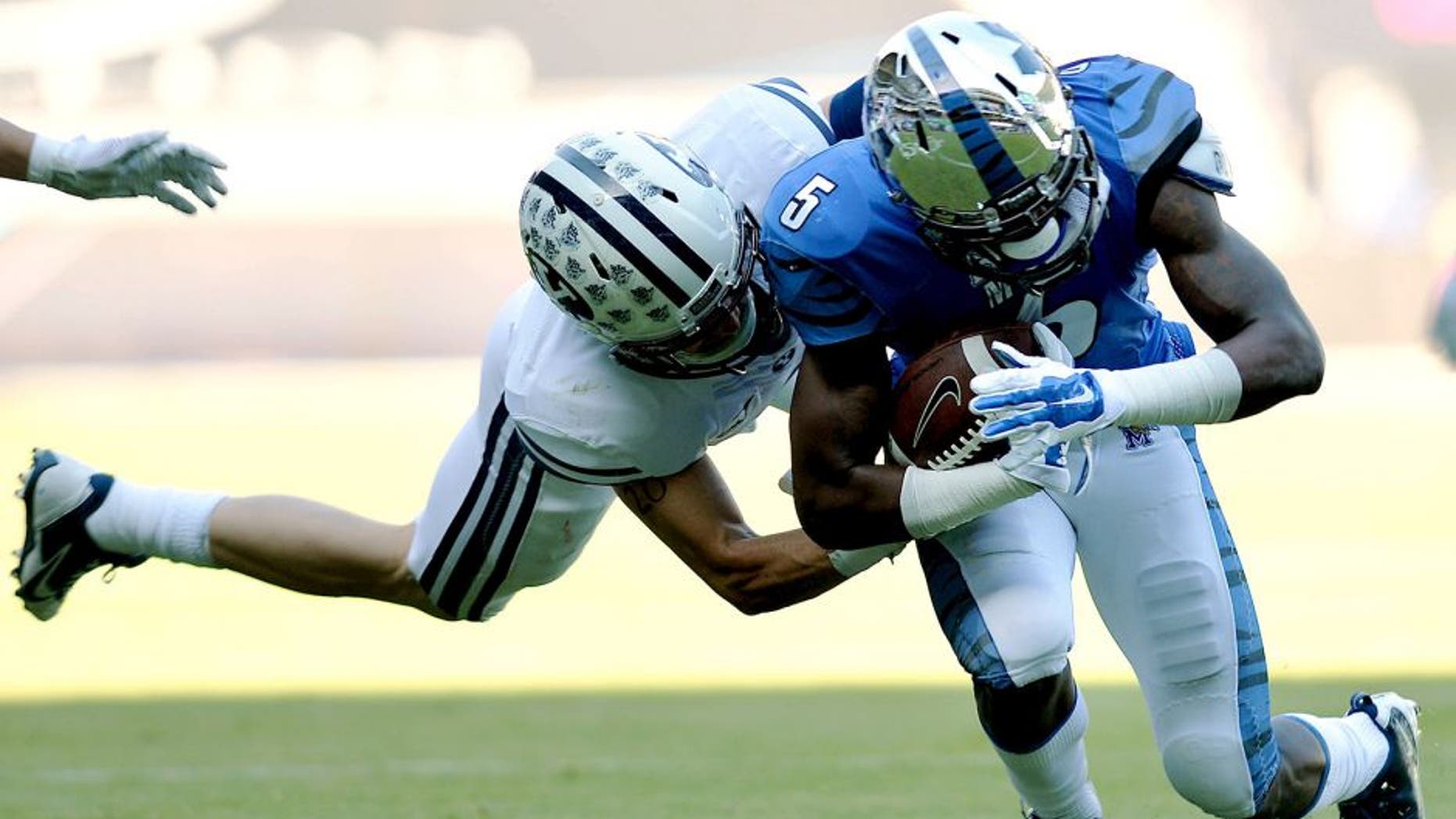Dec 22, 2014; Miami, FL, USA; Memphis Tigers wide receiver Mose Frazier (5) is tackled by Brigham Young Cougars linebacker Alani Fua (5) during the first quarter in the Miami Beach Bowl at Marlins Park. Mandatory Credit: Steve Mitchell-USA TODAY Sports