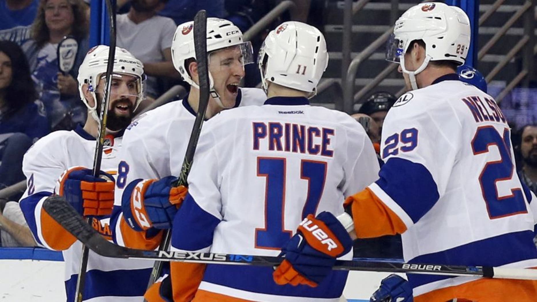TAMPA, FL - APRIL 27: Shane Prince #11 of the New York Islanders is congratulated on his goal by teammates Nick Leddy #2, Ryan Strome #18 and Brock Nelson #29 against the Tampa Bay Lightning during the first period in Game One of the Eastern Conference Second Round during the 2016 NHL Stanley Cup Playoffs at Amalie Arena on April 27, 2016 in Tampa, Florida. (Photo by Mike Carlson/Getty Images)