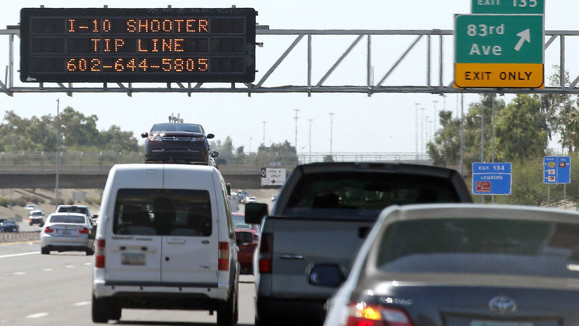 FILE - In this Sept. 11, 2015 file photo, a sign displays a shooter tip line above Interstate 10 in Phoenix.