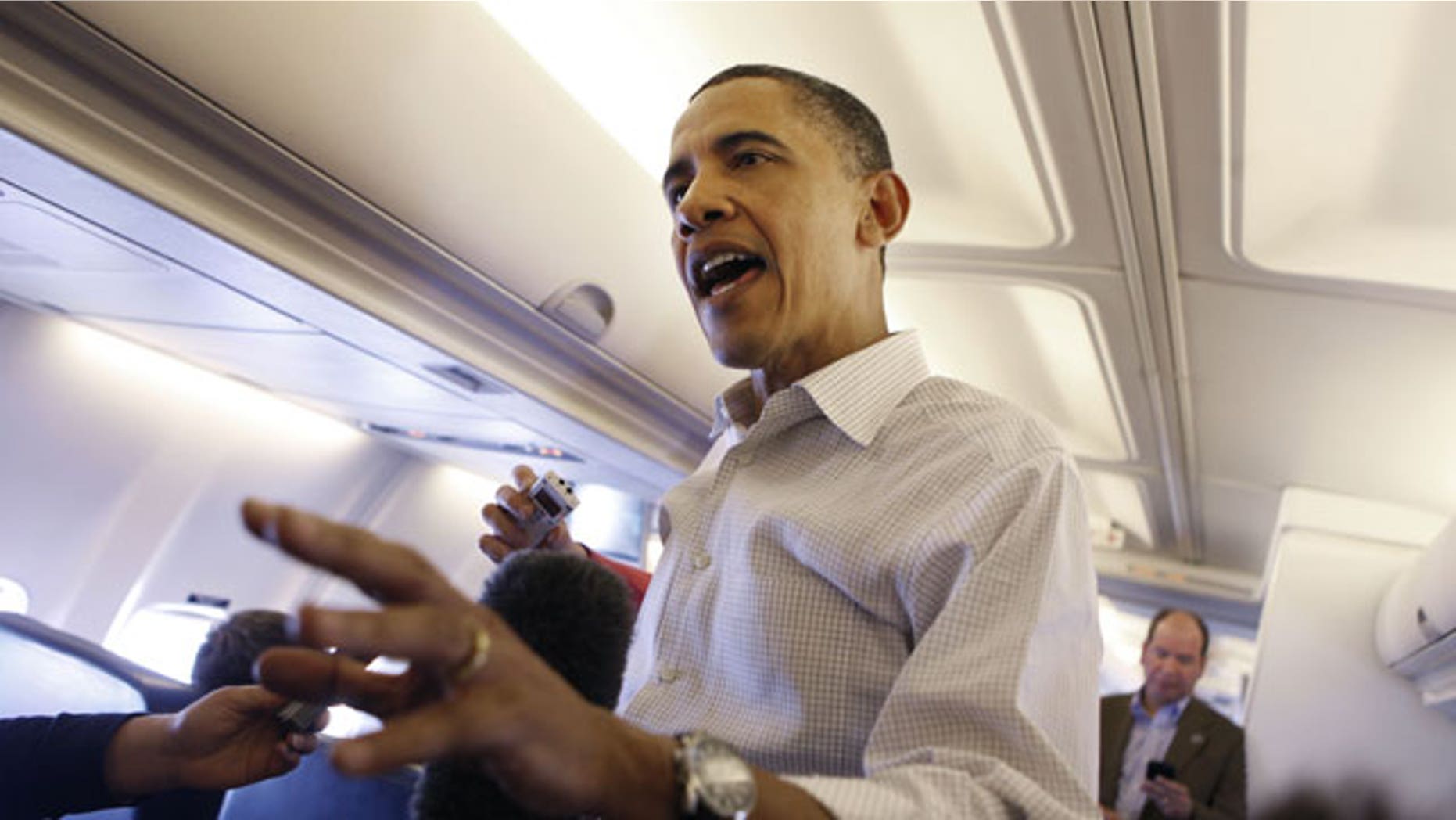 April 28: President Barack Obama answers question for members of the media aboard Air Force One entroute to Andrews Air Force Base.
