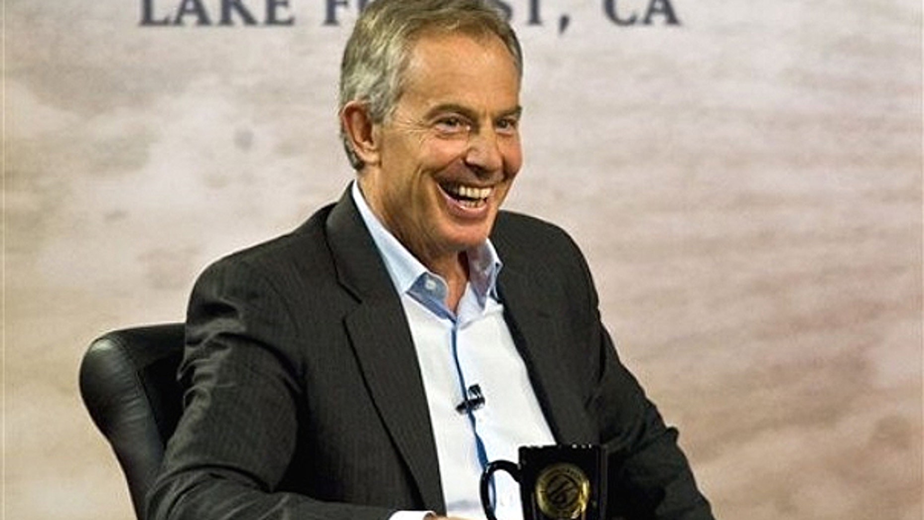 March 6: Former British Prime Minister Tony Blair laughs while talking with Pastor Rick Warren during the 'Civil Forum on Peace In a Globalized Economy' at Saddleback Church in Lake Forest, Calif.