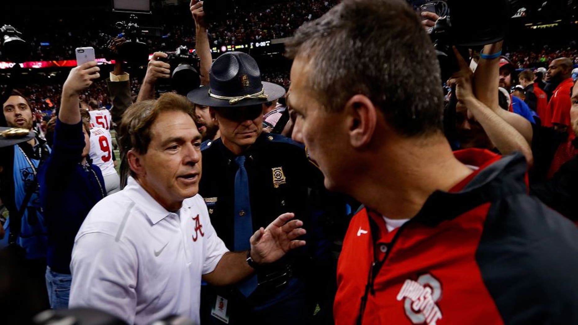 NEW ORLEANS, LA - JANUARY 01: Head coach Urban Meyer (R) of the Ohio State Buckeyes shakes hands with head coach Nick Saban (L) of the Alabama Crimson Tide after the All State Sugar Bowl at the Mercedes-Benz Superdome on January 1, 2015 in New Orleans, Louisiana. The Ohio State Buckeyes defeated the Alabama Crimson Tide 42 to 35. (Photo by Sean Gardner/Getty Images)