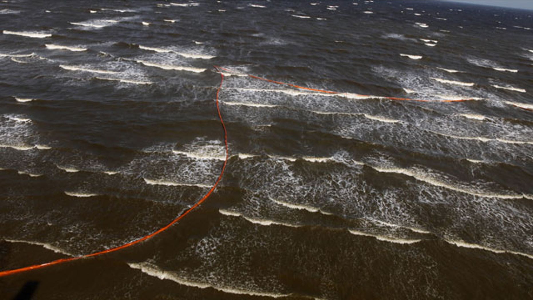 April 29: Oil booms that were placed in preparation of the looming oil spill from last week's collapse and spill of the Deepwater Horizon oil rig are seen strewn along the shoreline from choppy seas in Port Eads, La.