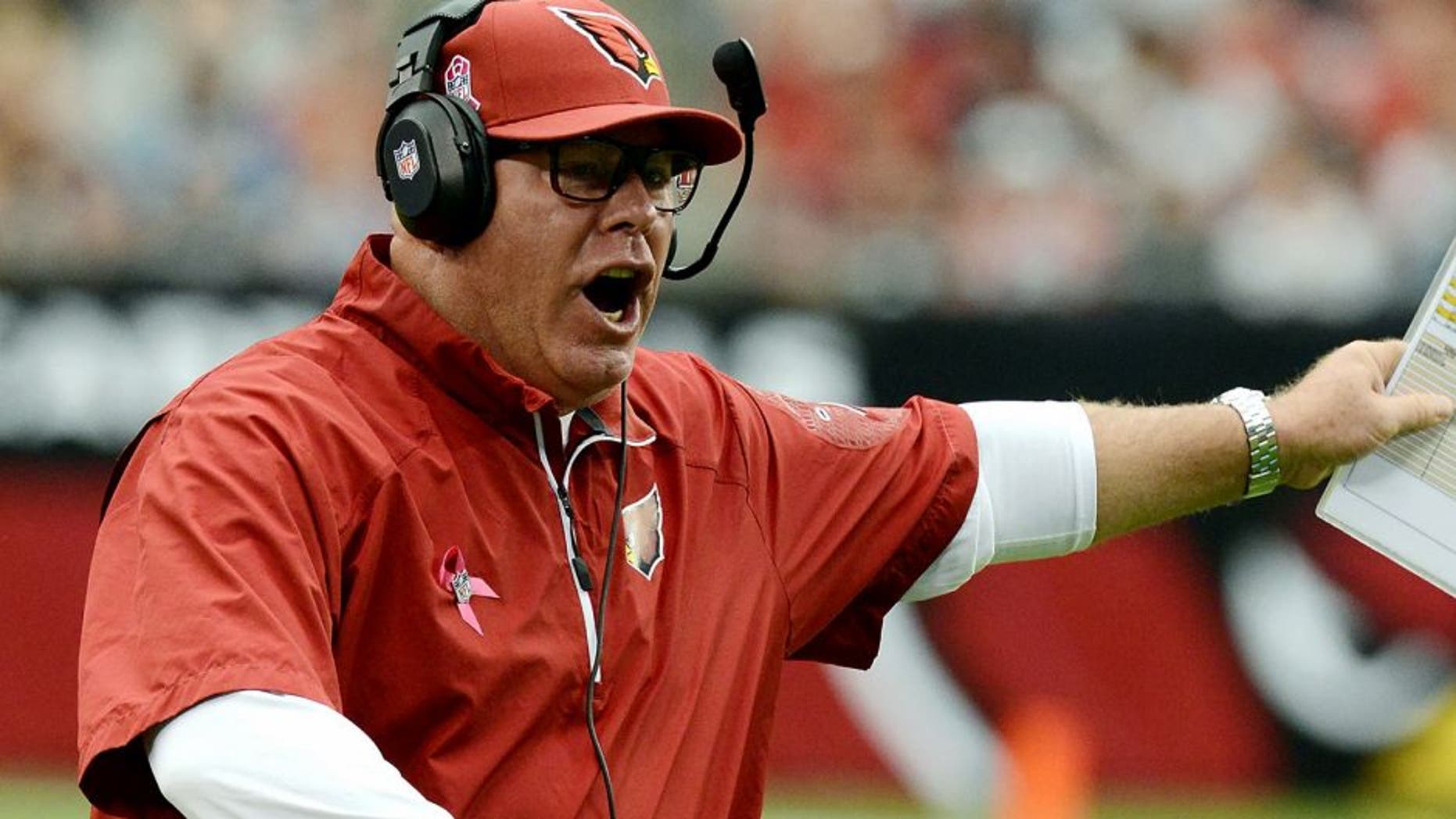 GLENDALE, AZ - OCTOBER 06: Head Coach Bruce Arians of the Arizona Cardinals disagrees with a call during a stop in play against the Carolina Panthers at University of Phoenix Stadium on October 6, 2013 in Glendale, Arizona. (Photo by Norm Hall/Getty Images)