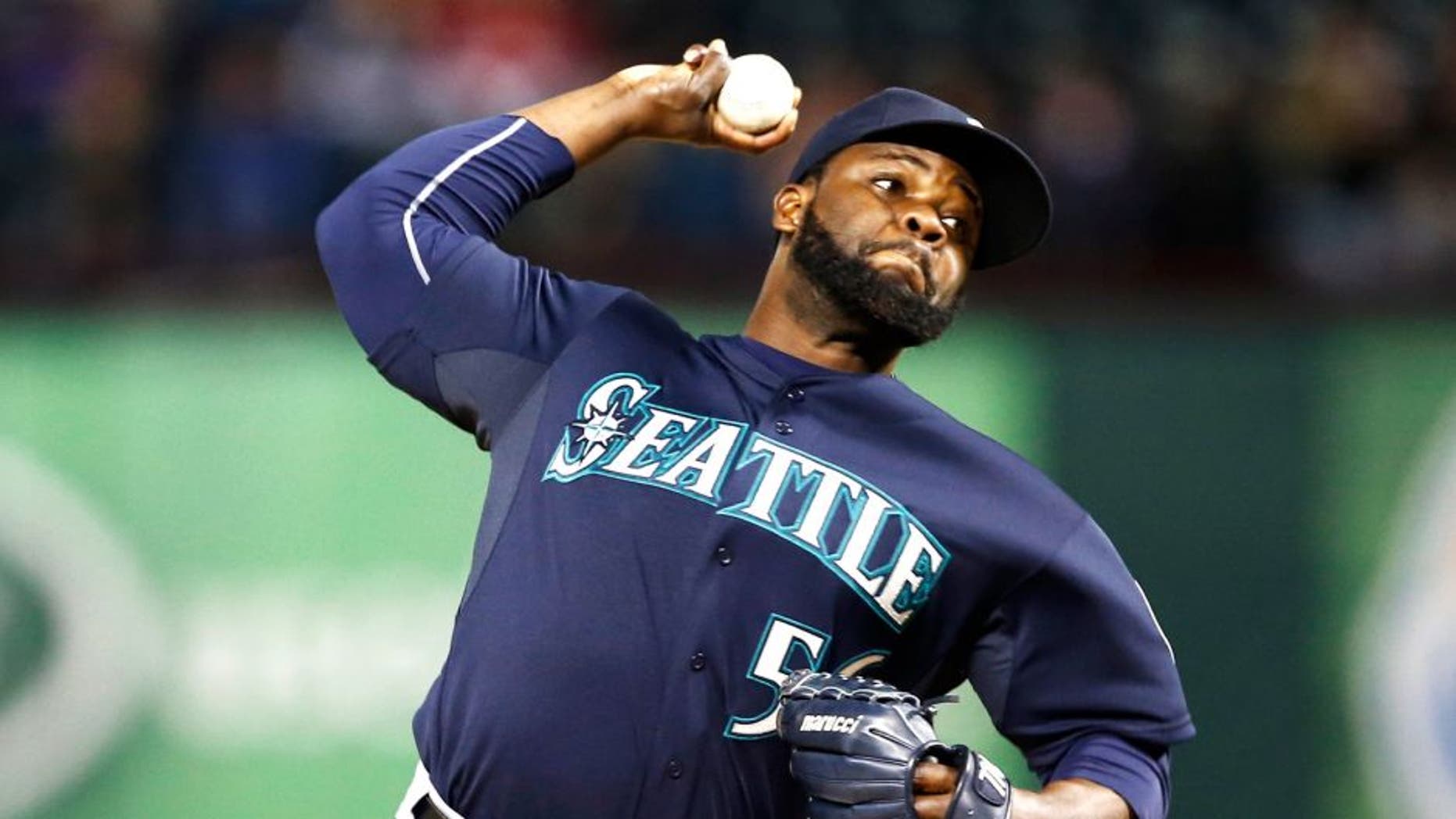 Apr 28, 2015; Arlington, TX, USA; Seattle Mariners relief pitcher Fernando Rodney (56) delivers a pitch to the Texas Rangers during the ninth inning of a baseball game at Globe Life Park in Arlington. The Mariners won 2-1. Mandatory Credit: Jim Cowsert-USA TODAY Sports
