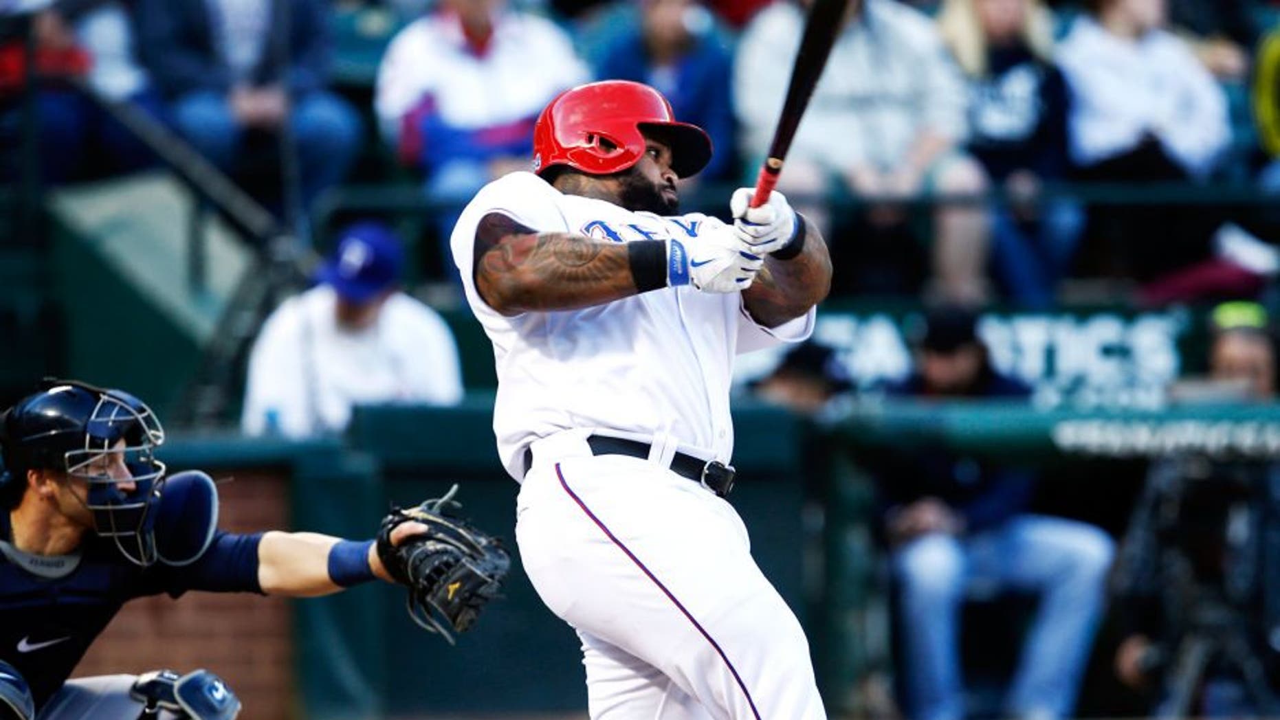 Apr 28, 2015; Arlington, TX, USA; Texas Rangers designated hitter Prince Fielder (84) follows through on his single against the Seattle Mariners during the first inning of a baseball game at Globe Life Park in Arlington. Mandatory Credit: Jim Cowsert-USA TODAY Sports