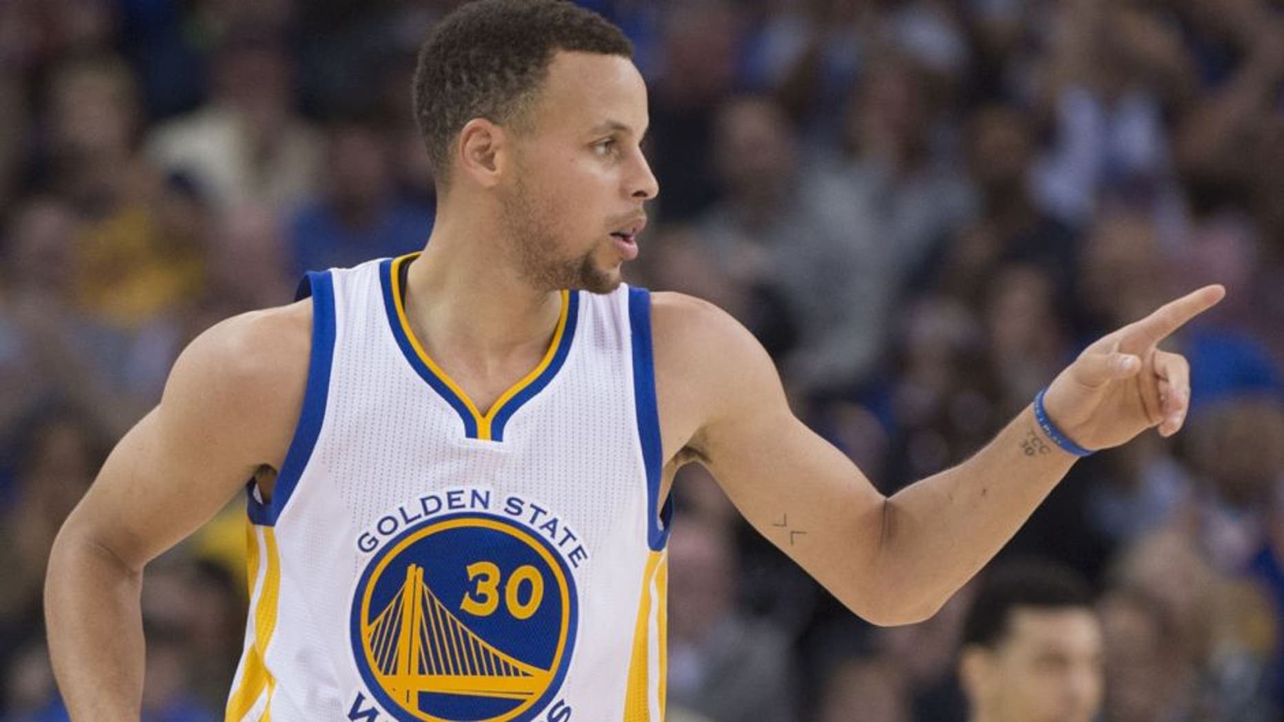 Golden State Warriors guard Stephen Curry (30) celebrates after making a three-point basket during the second quarter against the San Antonio Spurs at Oracle Arena. Mandatory Credit: Kyle Terada-USA TODAY Sports