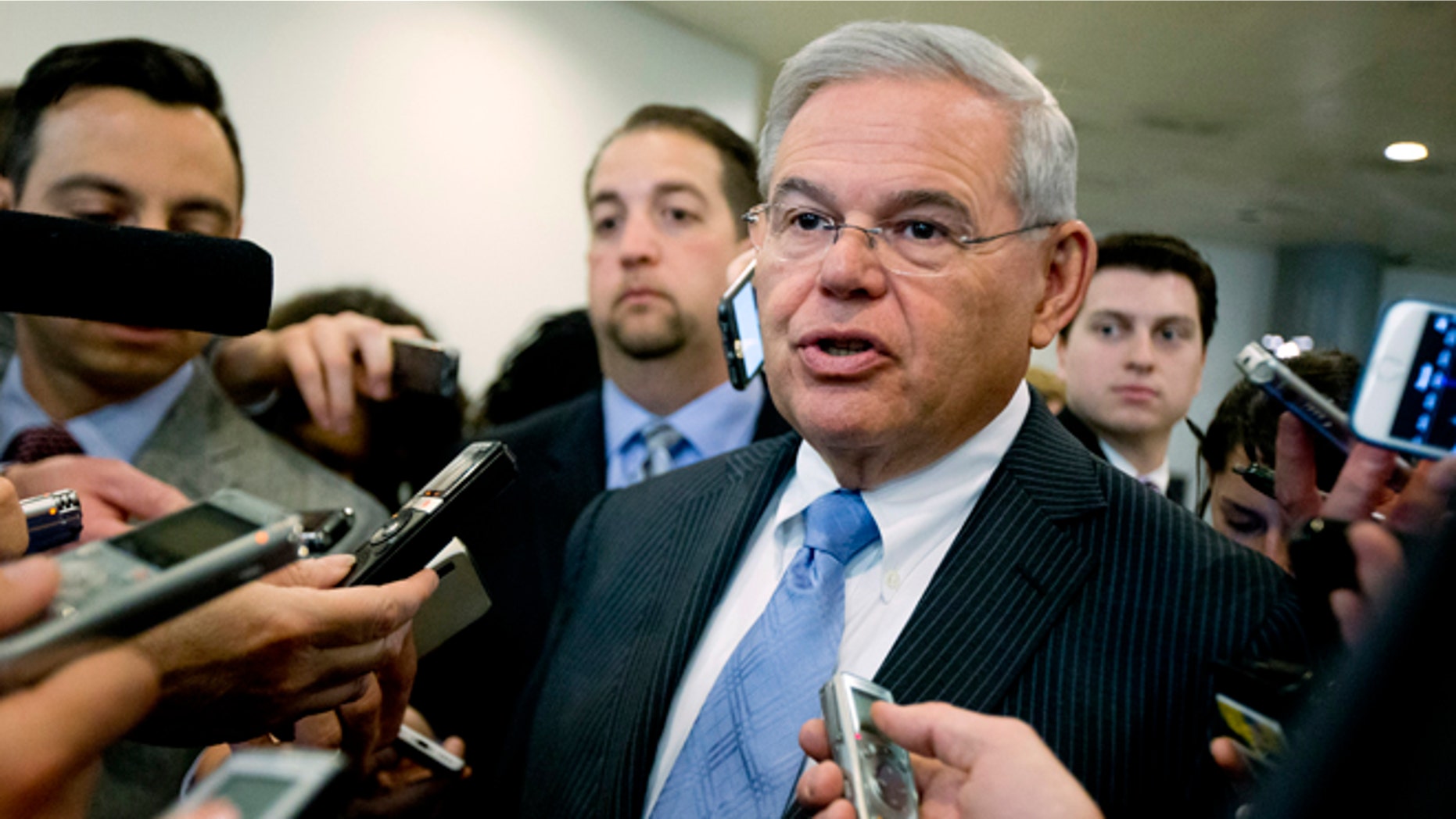 FILE - In this April 14, 2015, file photo, Sen. Robert Menendez, D-N.J. speaks with members of the media on Capitol Hill in Washington. Menendez, facing a federal indictment on bribery and corruption charges, reported his legal defense fund has raised nearly $1.3 million since it was launched last year and $430,000 from the start of this year until the day before he was indicted. Menendez, a Democrat, has denied any wrongdoing and vowed to fight the indictment, which alleges he helped his longtime friend and co-defendant, Florida eye doctor Salomon Melgen, with his business dealings in exchange for trips to a lavish villa in the Dominican Republic and campaign donations. (AP Photo/Manuel Balce Ceneta, File)