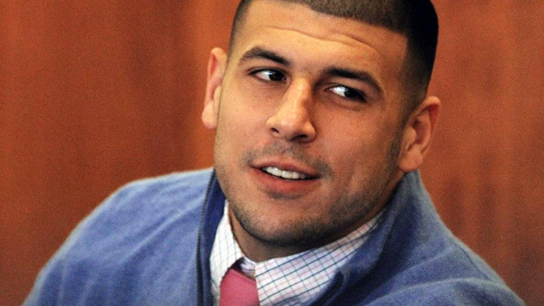 FILE - In this Oct. 1, 2014, file photo, former New England Patriots football player Aaron Hernandez looks back during an evidentiary hearing at Fall River Superior Court in Fall River, Mass. Hernandez is expected in court for the final pre-trial hearing in the first of two murder cases against him. Prosecutors and Hernandez’s lawyers on Tuesday, Jan. 6, 2015, are expected to take up remaining issues before jury selection begins on Friday in Bristol County Superior Court. Hernandez is charged with murder in the killing of semi-pro football player Odin Lloyd in 2013. (AP Photo/The Boston Globe, Wendy Maeda, Pool)