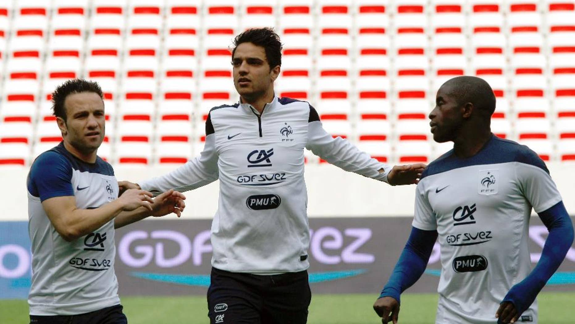 French soccer team midfielders Mathieu Valbuena, left, Clement Grenier, center, and Rio Mavuba, attends a training session, at the Allianz Riviera Stadium, in Nice, southeastern France, Saturday, May 31, 2014. France, which will face Paraguay on Sunday, is preparing for the upcoming soccer World Cup in Brazil starting on 12 June. (AP Photo/Claude Paris)
