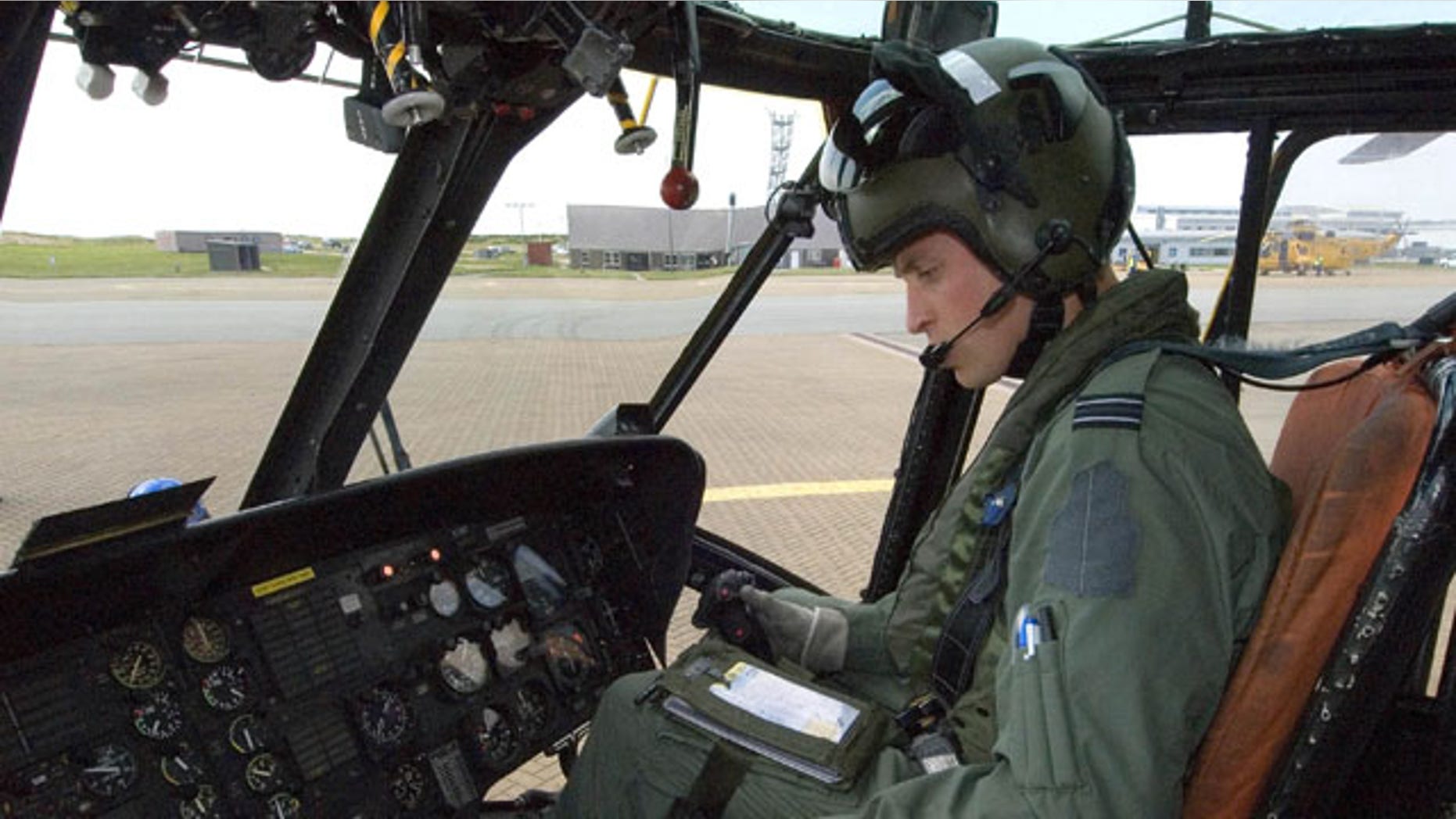 This image released by the British Ministry of Defense on Friday Sept. 17, 2010 shows Prince William at the controls of his Sea King helicopter in Bangor, Wales.