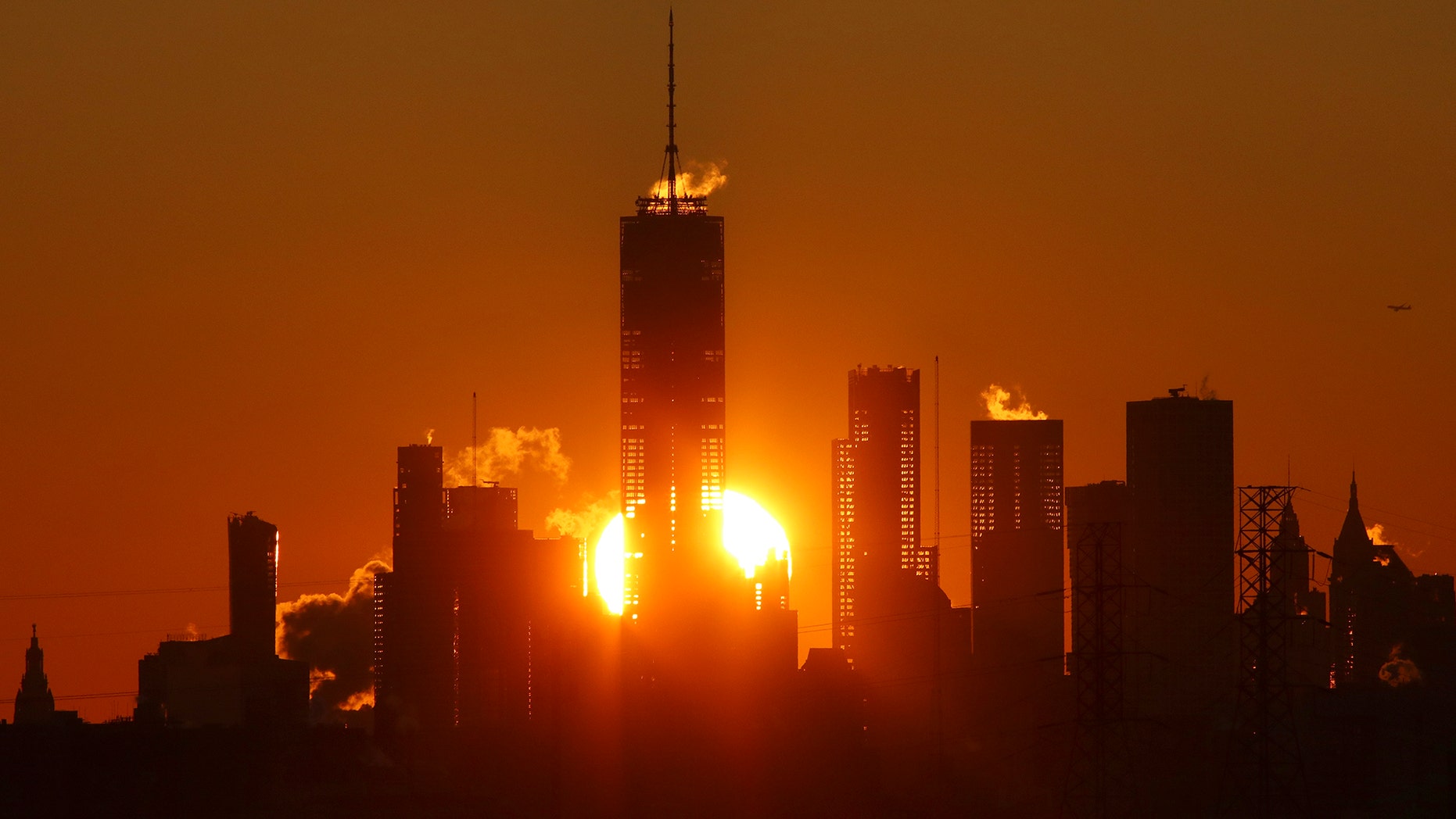 KEARNY, NJ - JANUARY 7: The sun rises behind the skyline of lower Manhattan and One World Trade Center in New York City on January 7, 2018, as seen from Kearny, New Jersey. (Photo by Gary Hershorn/Corbis via Getty Images)