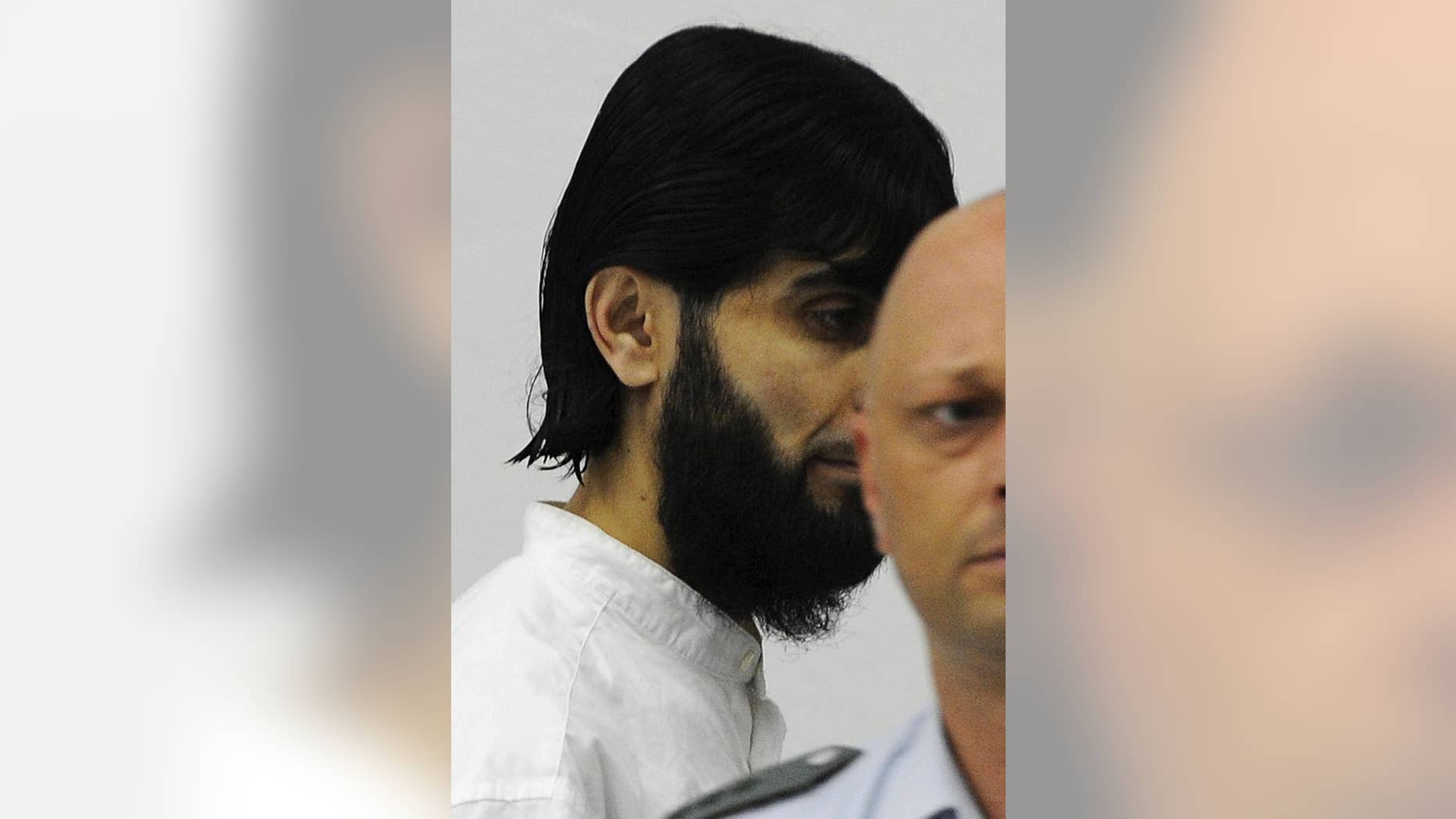 FILE - In his July 15, 2008 file photo Rafik Mohamad Yousef, one of the three defendants, enters the dock at the Higher Regional Court in Stuttgart, southern Germany. German prosecutors said the known Islamic extremist has been shot and killed by police after he attacked an officer with a knife in Berlin on Thursday, Sept. 17, 2015. (AP Photo/Daniel Maurer, file)