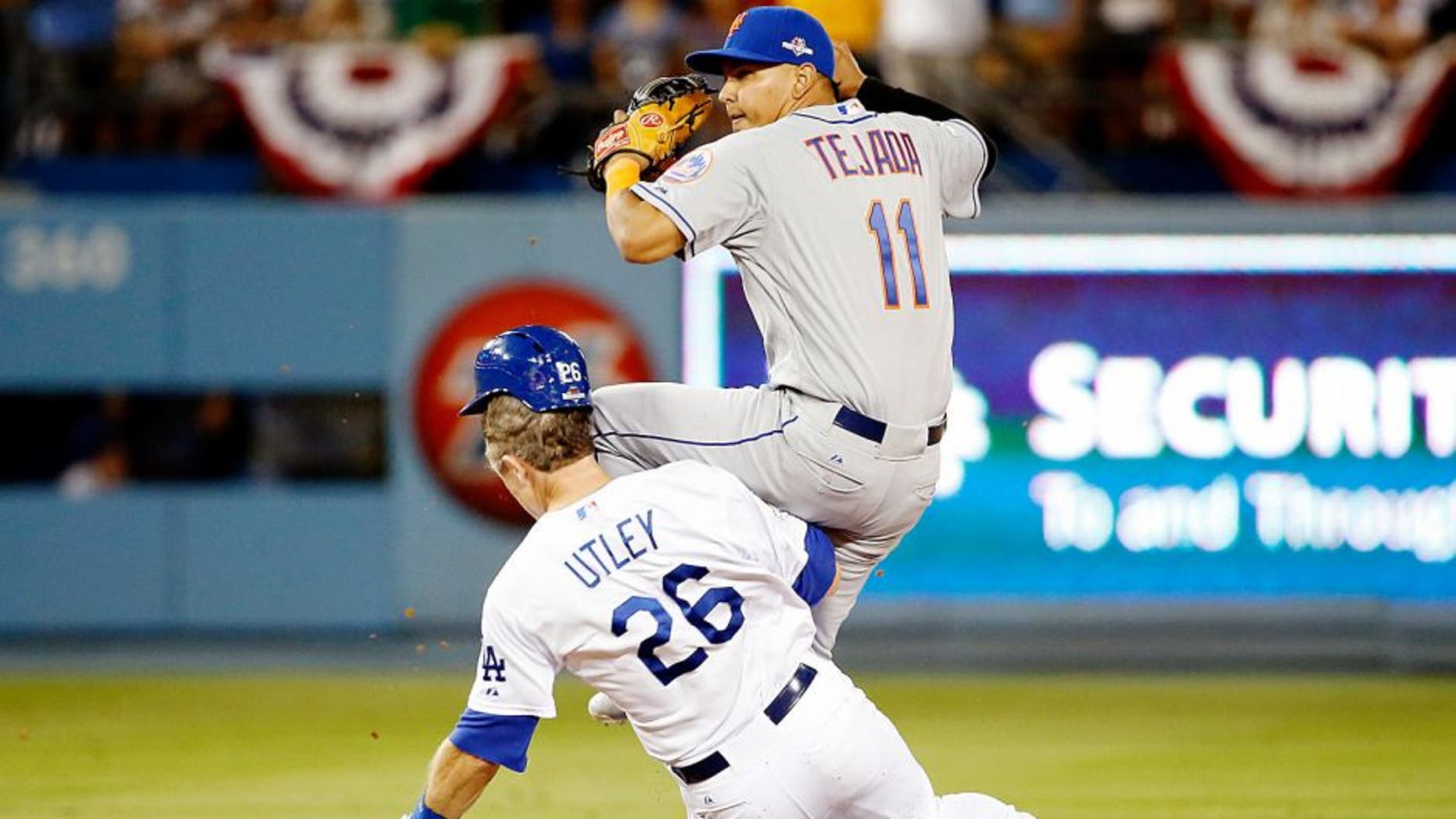 LOS ANGELES, CA - OCTOBER 10: Ruben Tejada #11 of the New York Mets is hit by a slide by Chase Utley #26 of the Los Angeles Dodgers in the seventh inning in an attempt to turn a double play in game two of the National League Division Series at Dodger Stadium on October 10, 2015 in Los Angeles, California. (Photo by Sean M. Haffey/Getty Images)