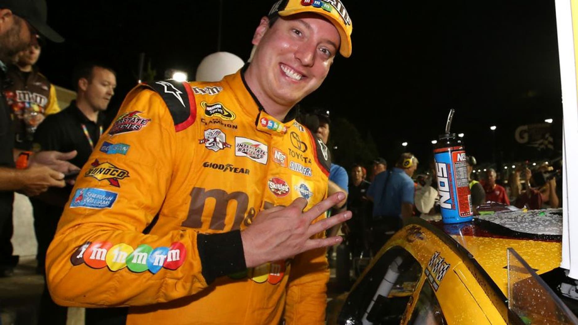 KANSAS CITY, KS - MAY 07: Kyle Busch, driver of the #18 M&M's Red Nose Toyota, celebrates after winning the NASCAR Sprint Cup Series Go Bowling 400 at Kansas Speedway on May 7, 2016 in Kansas City, Kansas. (Photo by Sean Gardner/NASCAR via Getty Images)