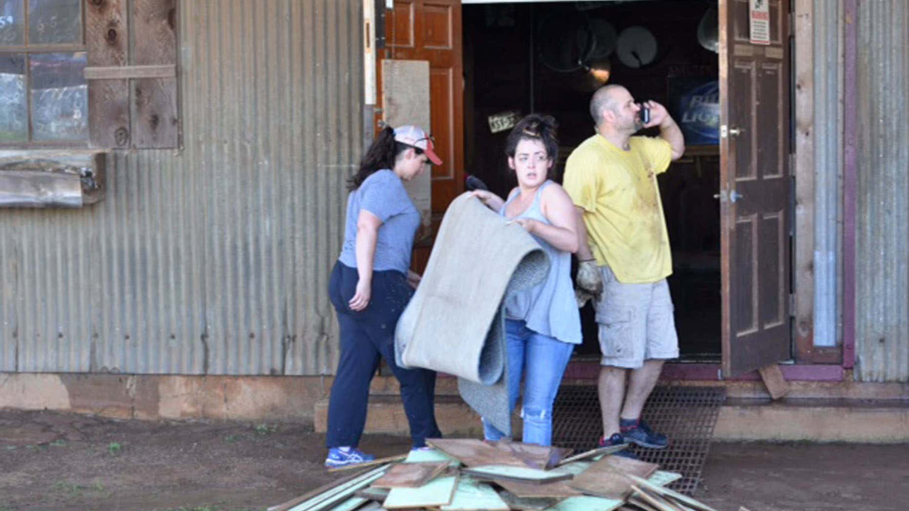 April 29, 2016: Friends, staff and volunteers work to clean up the Shelton Gin in Palestine, Texas after a flash flood.