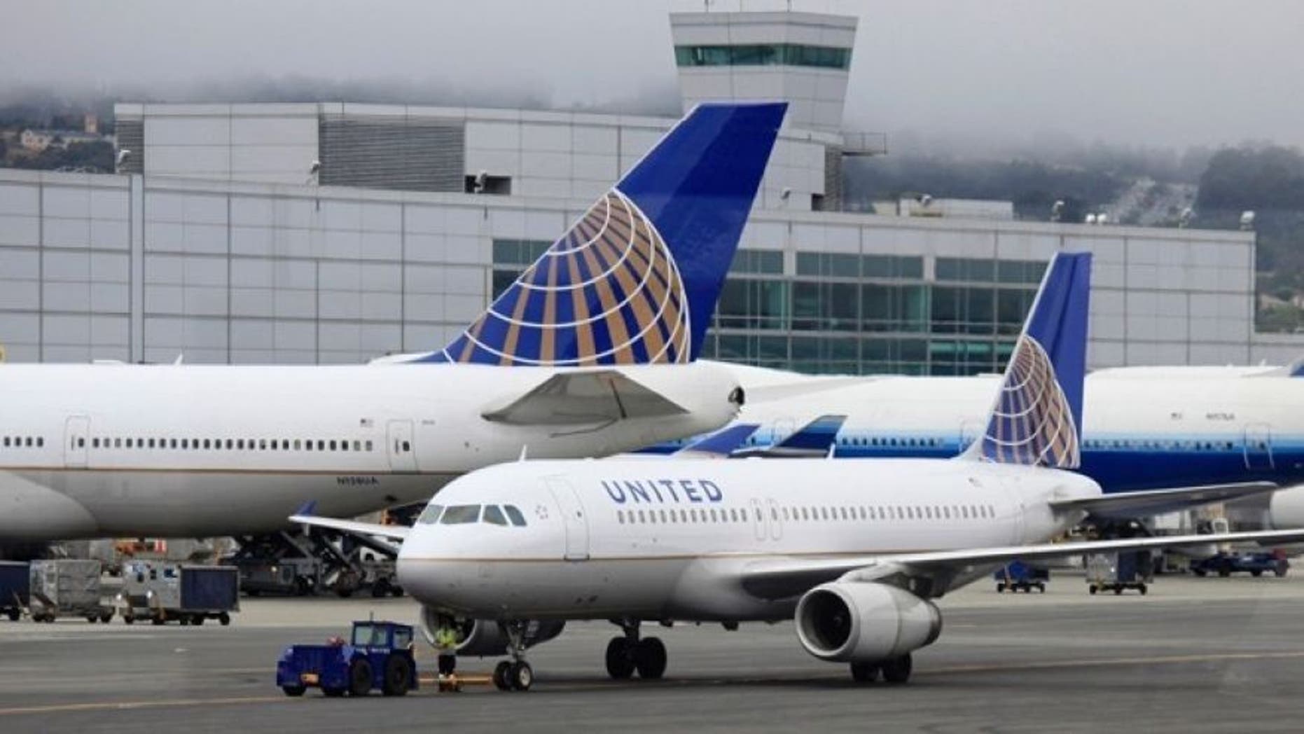 At least five people suffered minor injuries Tuesday night after a United Airlines plane engine caught fire at Newark Liberty International Airport, officials said.