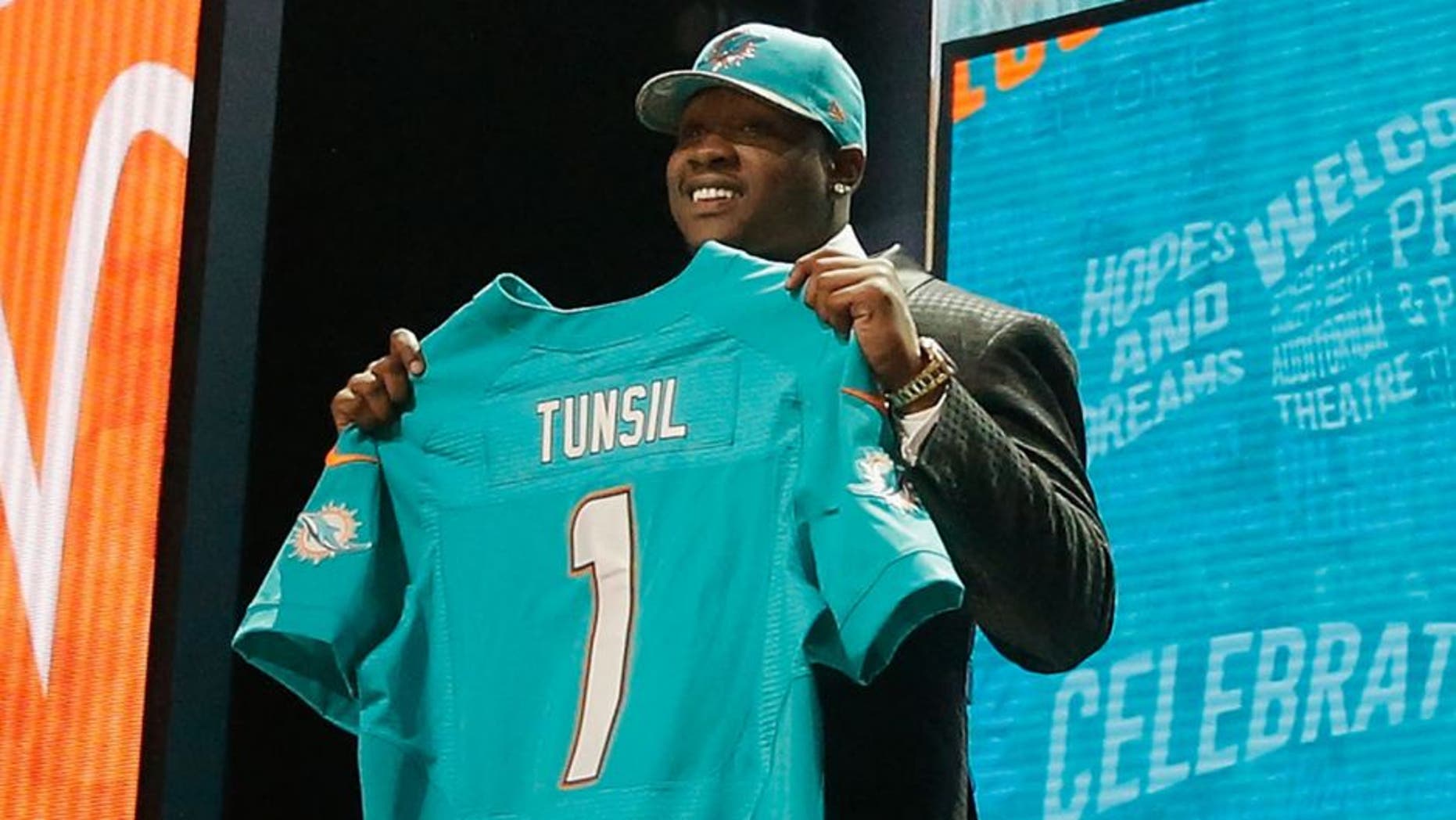 CHICAGO, IL - APRIL 28: Laremy Tunsil of Ole Miss holds up a jersey after being picked #13 overall by the Miami Dolphins during the first round of the 2016 NFL Draft at the Auditorium Theatre of Roosevelt University on April 28, 2016 in Chicago, Illinois. (Photo by Jon Durr/Getty Images)