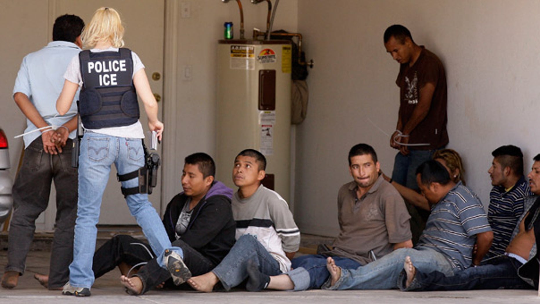 FILE: Agents raid a drop house for illegal immigrants in Phoenix in April.