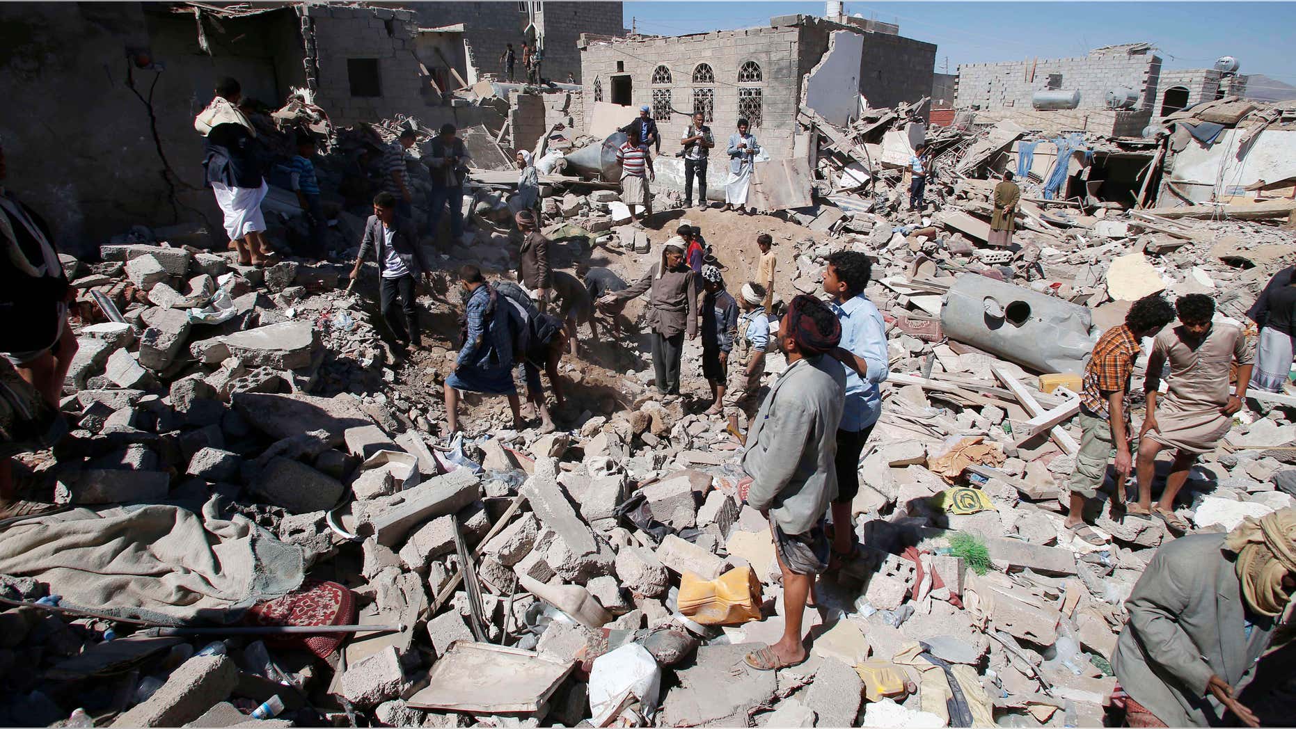 May 1, 2015: People search for survivors under the rubble of houses destroyed by Saudi-led airstrikes in Sanaa, Yemen.