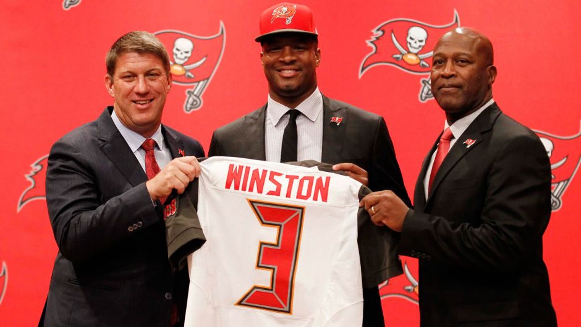 May 1, 2015; Tampa, FL, USA; Tampa Bay Buccaneers quarterback Jameis Winston (3), the number one overall draft pick, poses with general manager Jason Licht and head coach Lovie Smith for a photo during a press conference at One Buc Place. Mandatory Credit: Kim Klement-USA TODAY Sports