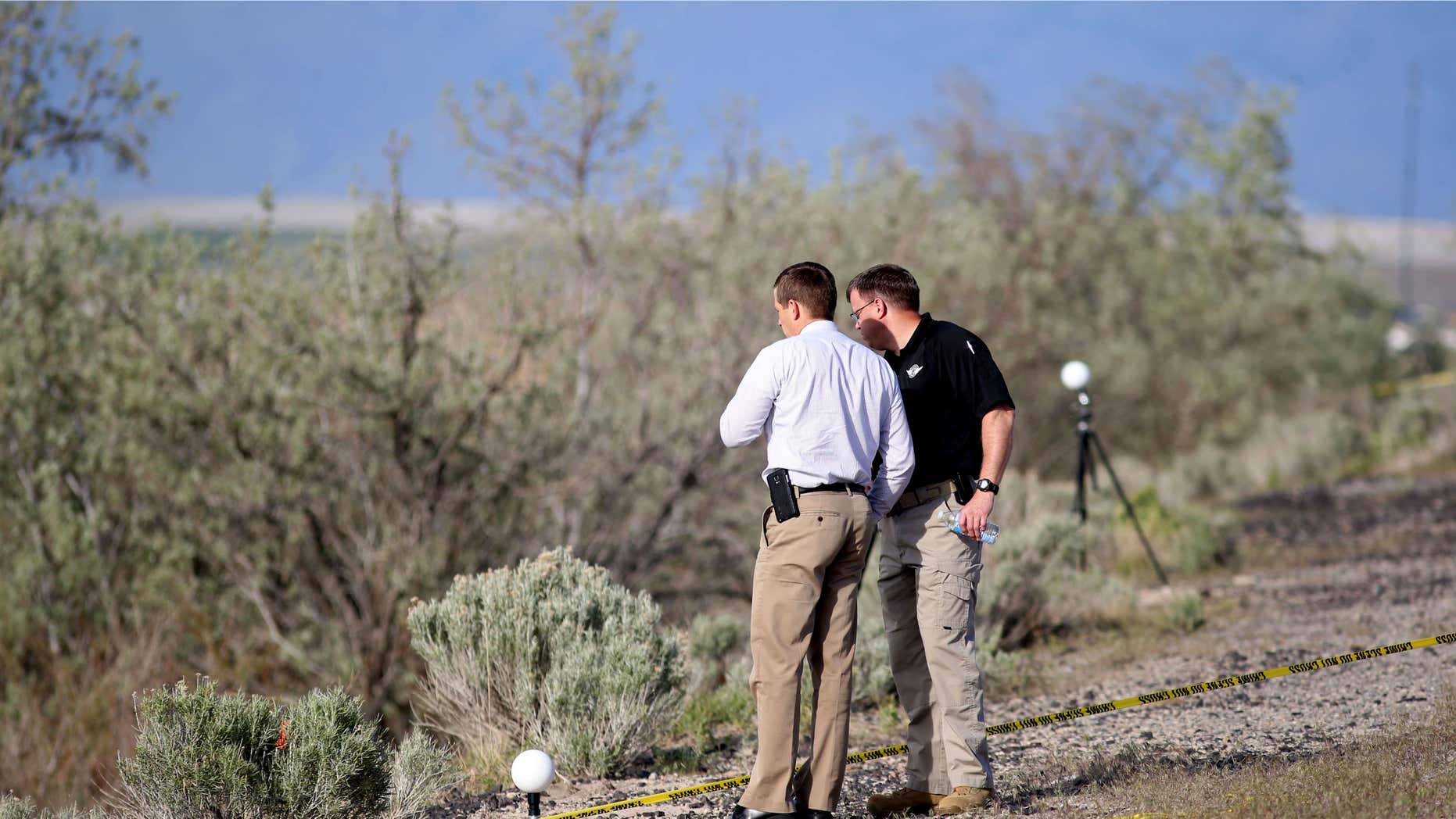 April 30, 2015: Officers with the Department of Public Safety State Bureau of Investigation process the scene where human remains inside a suitcase were discovered on the side of I-80 near Saltair in Magna, Utah.