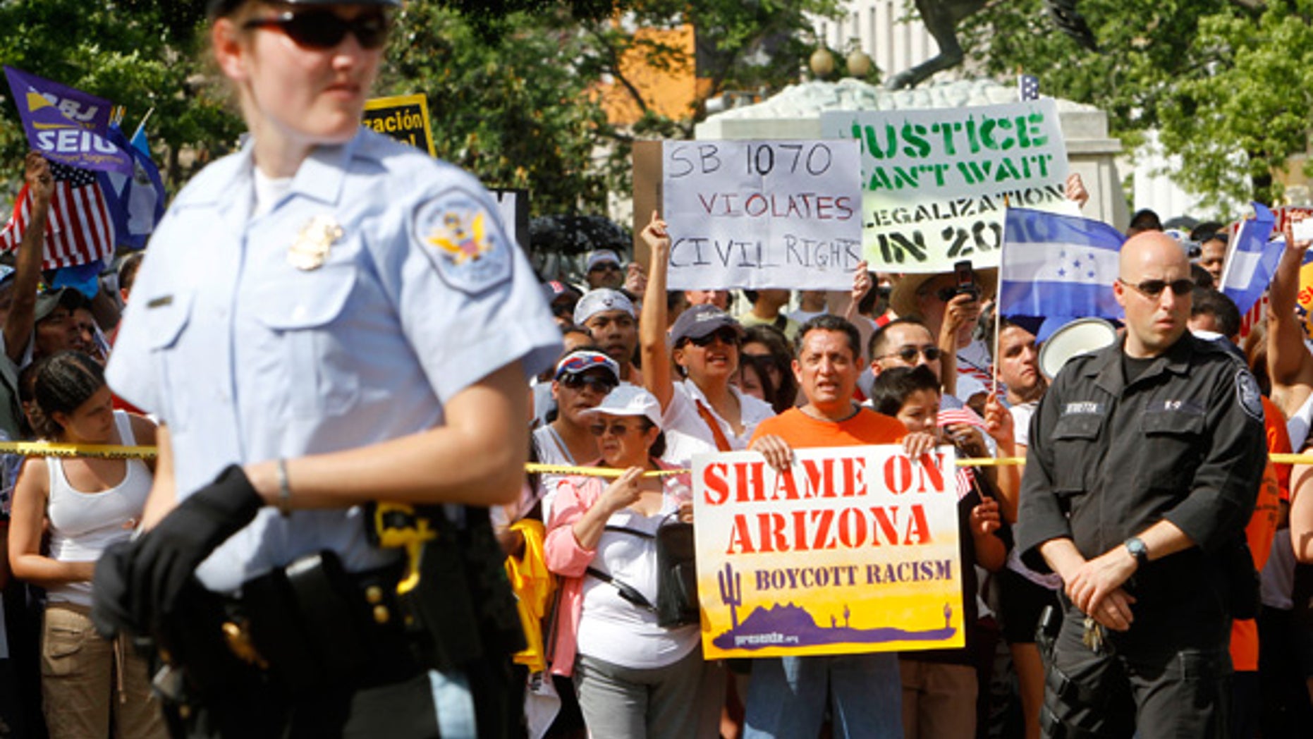 May 1: Protesters hold signs against Arizona's tough new immigration law, near the White House.