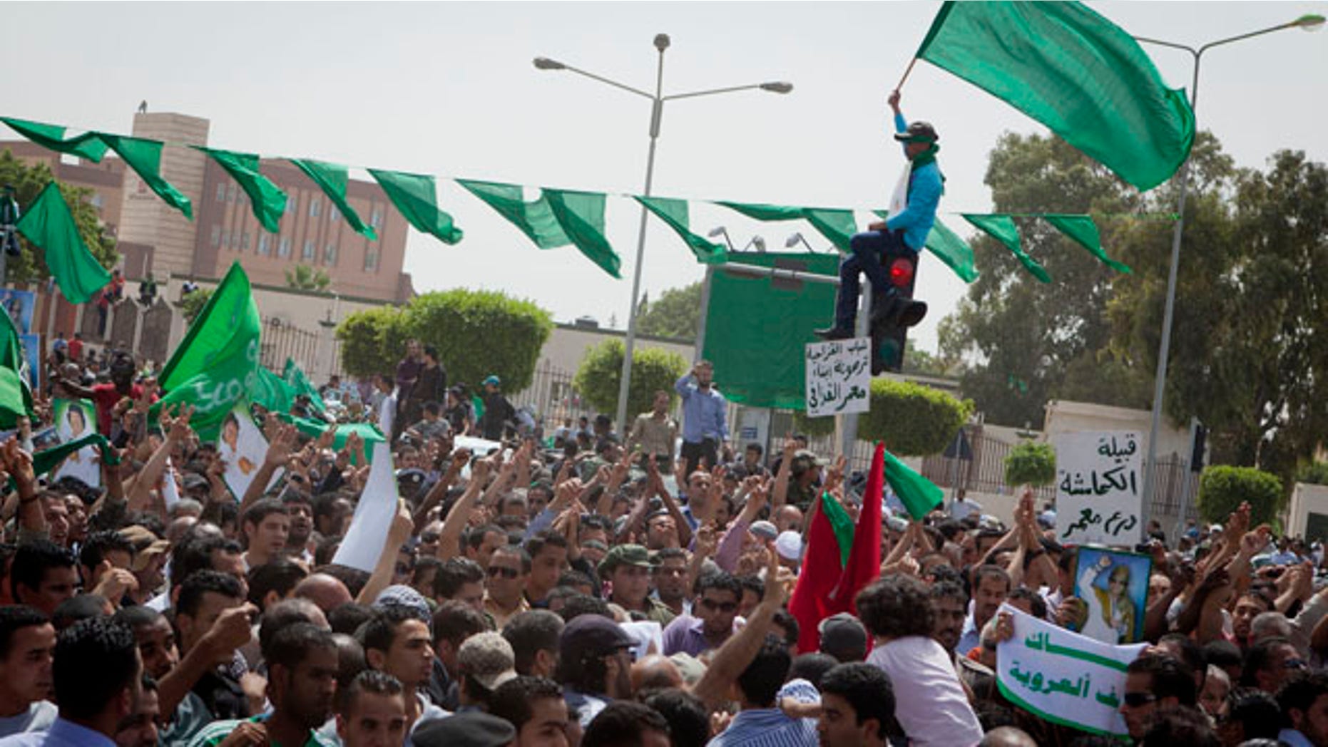 May 2: In this photo made on a government organized tour, supporters attend a funeral ceremony for members of the Qaddafi family in Tripoli, Libya.