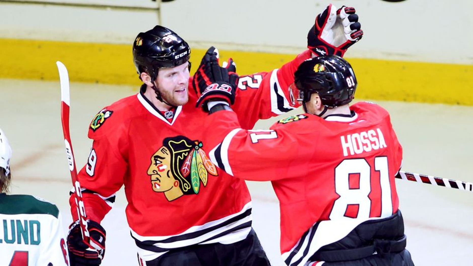 May 4, 2014; Chicago, IL, USA; Chicago Blackhawks left wing Bryan Bickell (29) celebrates with right wing Marian Hossa (81) after scoring a goal against the Minnesota Wild during the third period in game two of the second round of the 2014 Stanley Cup Playoffs at United Center. Mandatory Credit: Jerry Lai-USA TODAY Sports