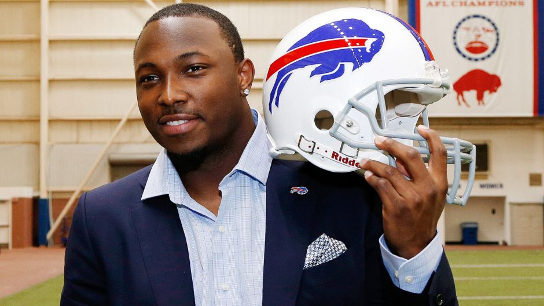 Mar 10, 2015; Orchard Park, NY, USA; Buffalo Bills running back LeSean McCoy poses with a Bills helmet in the AD Pro training facility after a press conference at Ralph Wilson Stadium. Mandatory Credit: Kevin Hoffman-USA TODAY Sports