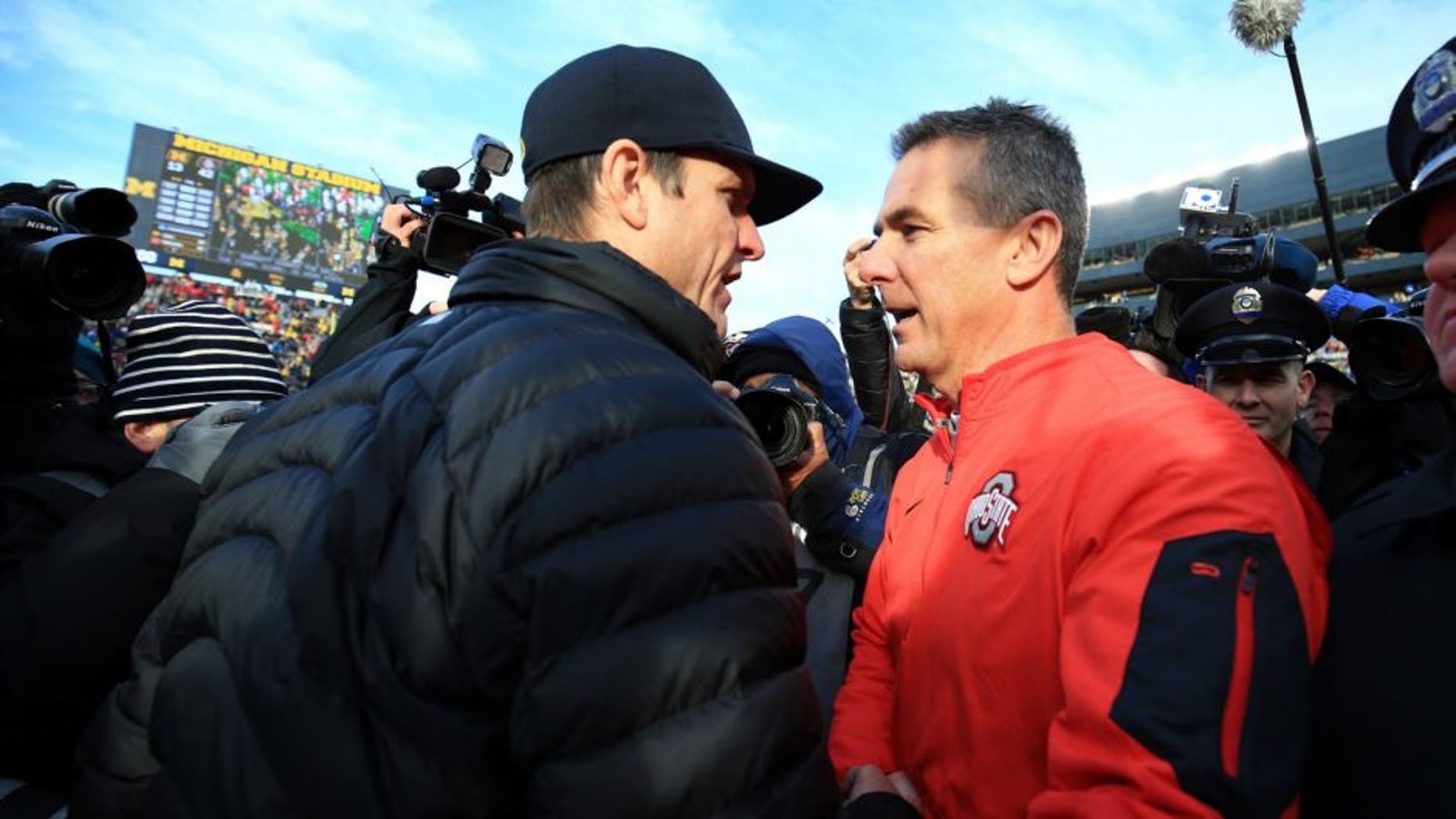 ANN ARBOR, MI - NOVEMBER 28: Head coach Urban Meyer of the Ohio State Buckeyes and head coach Jim Harbaugh of the Michigan Wolverines after the game against the Michigan Wolverines at Michigan Stadium on November 28, 2015 in Ann Arbor, Michigan. Ohio State defeated Michigan 42-13. (Photo by Andrew Weber/Getty Images) *** Local Caption *** Urban Meyer; Jim Harbaugh