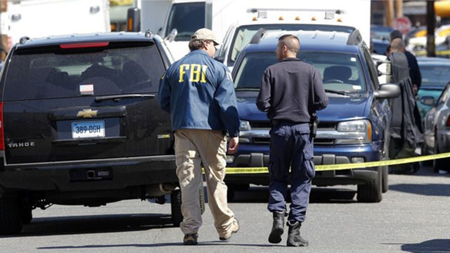 May 4: FBI personnel walk down the street of Pakistani-American Faisal Shahzad on Sheridan Street in Bridgeport, Connecticut.