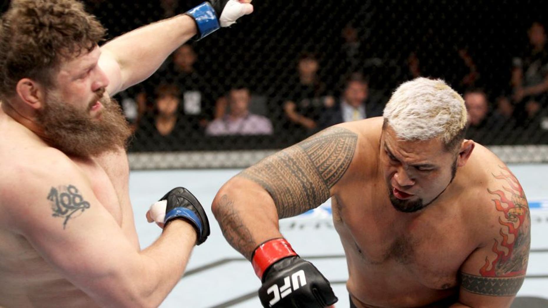 SAITAMA, JAPAN - SEPTEMBER 20: Mark Hunt throws a punch at Roy Nelson in their heavyweight bout during the UFC Fight Night event inside the Saitama Arena on September 20, 2014 in Saitama, Japan. (Photo by Mitch Viquez/Zuffa LLC/Zuffa LLC via Getty Images)