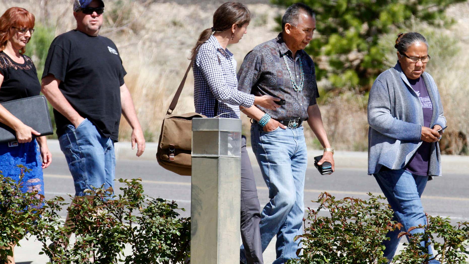 San Juan Chapter President Rick Nez, second from right, walks out of the Farmington Municipal Court building on Wednesday, May 4, 2016 after an initial court hearing for Tom Begaye, who has been accused of abducting and killing 11-year-old Ashlynne Mike.