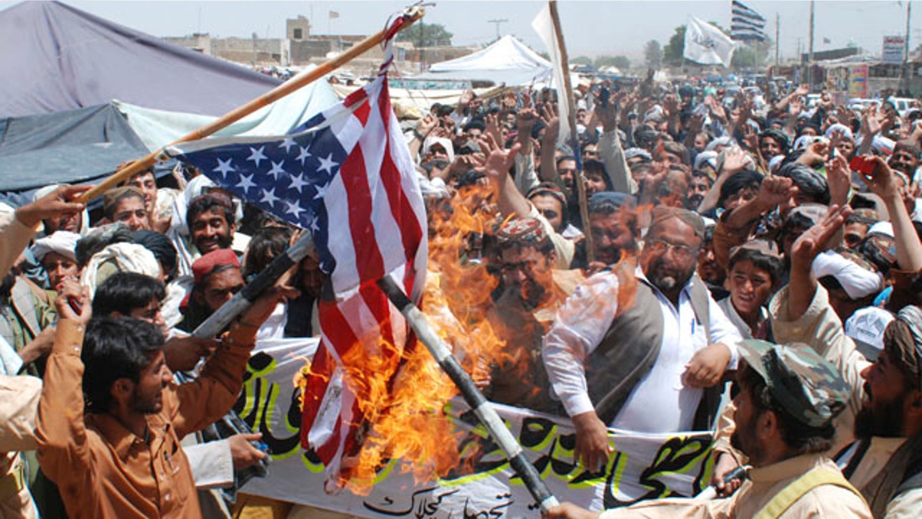 May 6: Supporters of Pakistani religious party Jamiat Ulema-e-Islam burn representation of a U. S. flag during a rally to condemn the killing of Al Qaeda leader Usama bin Laden, in Kuchlak, Pakistan.