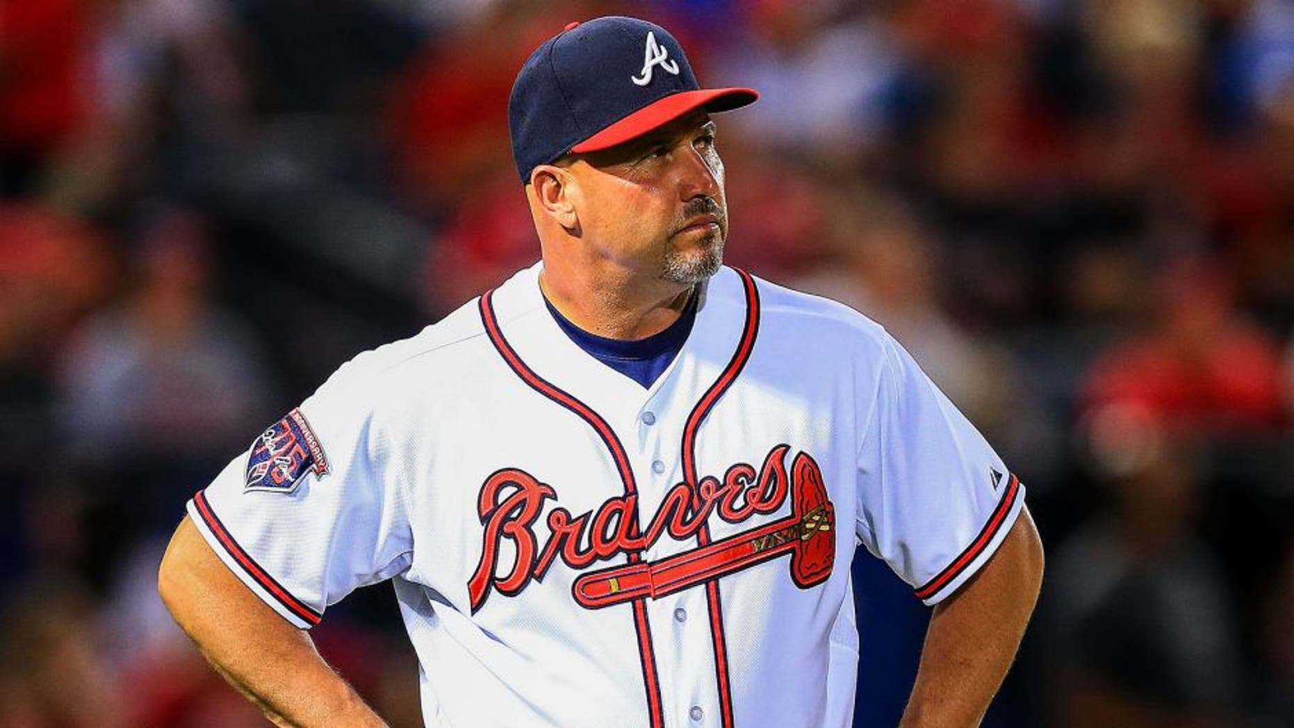 May 5, 2014; Atlanta, GA, USA; Atlanta Braves manager Fredi Gonzalez (33) waits on the field during a replay challenge in the sixth inning against the St. Louis Cardinals at Turner Field. Mandatory Credit: Daniel Shirey-USA TODAY Sports