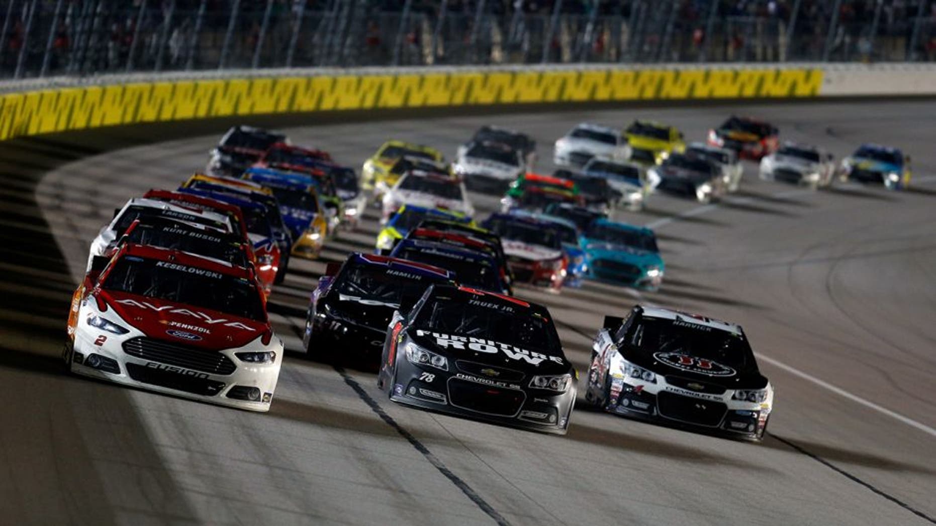 KANSAS CITY, KS - MAY 09: Brad Keselowski, driver of the #2 Avaya Ford, Martin Truex Jr., driver of the #78 Furniture Row/Visser Precision Chevrolet, and Kevin Harvick, driver of the #4 Jimmy John's/Budweiser Chevrolet, lead the field during the NASCAR Sprint Cup Series SpongeBob SquarePants 400 at Kansas Speedway on May 9, 2015 in Kansas City, Kansas. (Photo by Todd Warshaw/NASCAR via Getty Images)