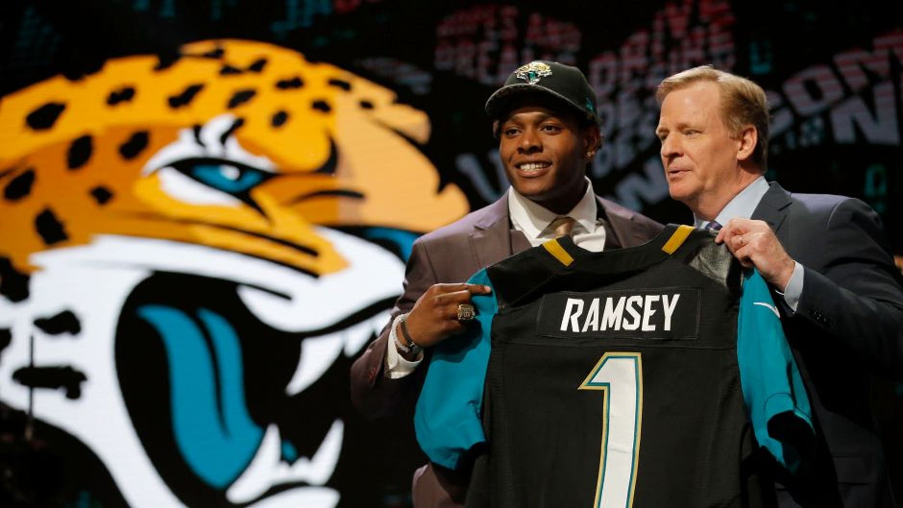 CHICAGO, IL - APRIL 28: (L-R) Jalen Ramsey of the Florida State Seminoles holds up a jersey with NFL Commissioner Roger Goodell after being picked #5 overall by the Jacksonville Jaguarsduring the first round of the 2016 NFL Draft at the Auditorium Theatre of Roosevelt University on April 28, 2016 in Chicago, Illinois. (Photo by Jon Durr/Getty Images)