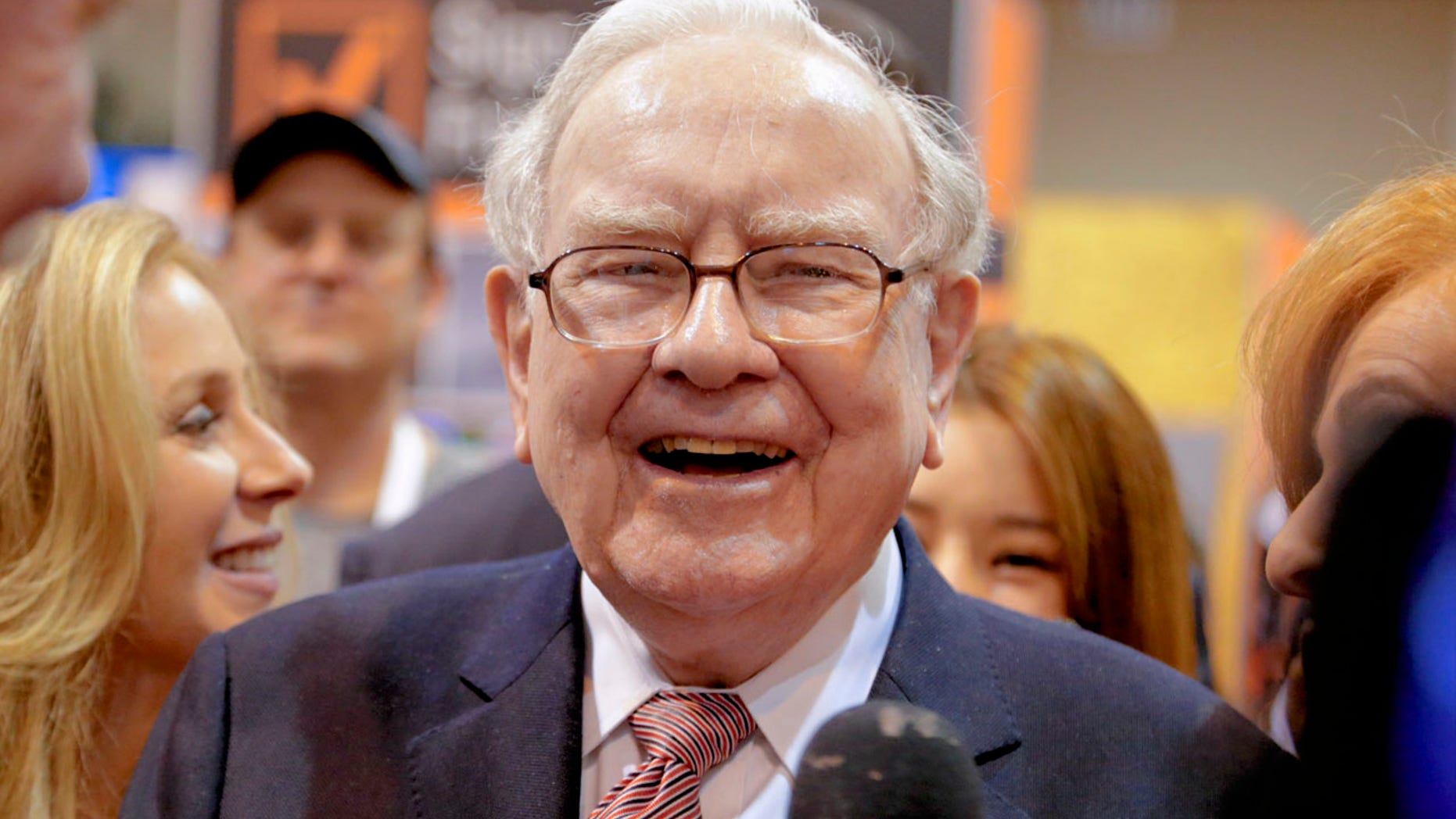 Berkshire Hathaway Chairman and CEO Warren Buffett laughs while touring the exhibit floor at the CenturyLink Center in Omaha, Neb., Saturday, May 6, 2017, where company subsidiaries display their products.