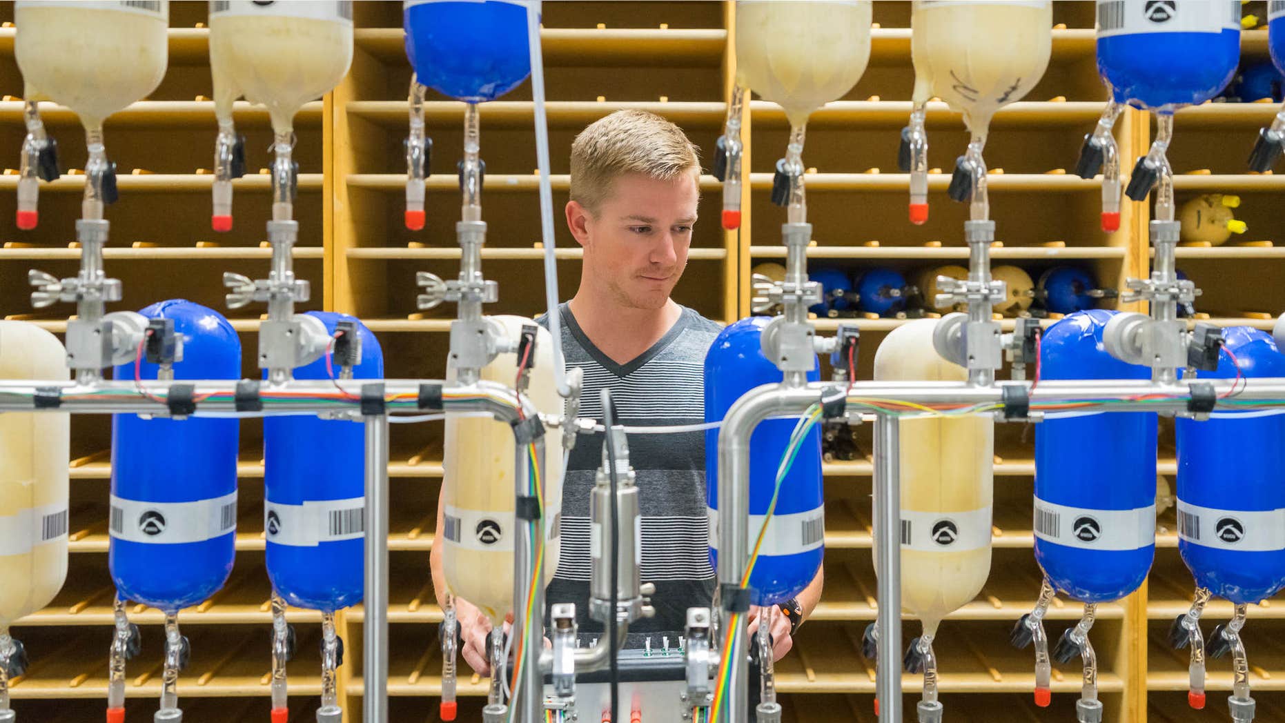 May 2014: This handout photo provided by NOAA shows Eric Moglia of NOAA's Cooperative Institute for Research in Environmental Sciences, prepares air sample canisters at NOAA’s Earth System Research Laboratory in Boulder, Colo.