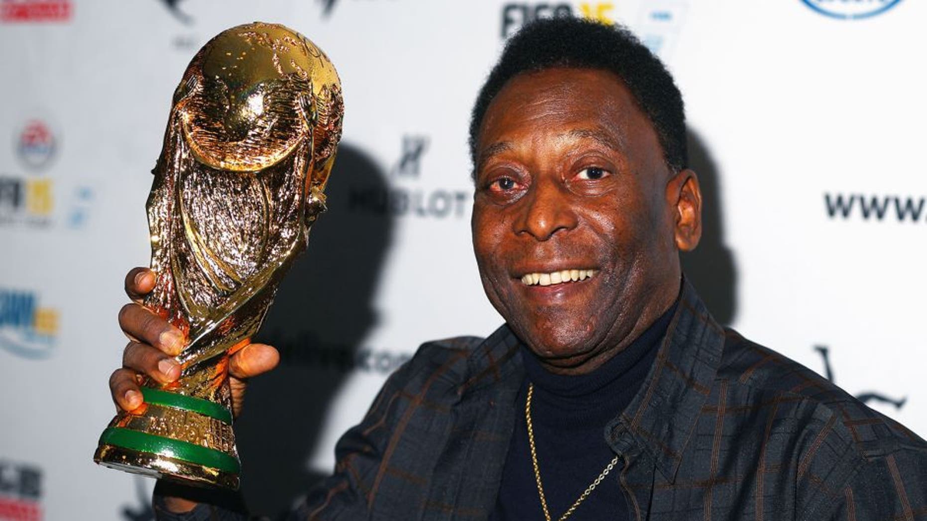 MELBOURNE, AUSTRALIA - MARCH 26: Pele holds a replica Wolrd Cup trophy during a press conference at The Peninsula on March 26, 2015 in Melbourne, Australia. (Photo by Robert Cianflone/Getty Images)