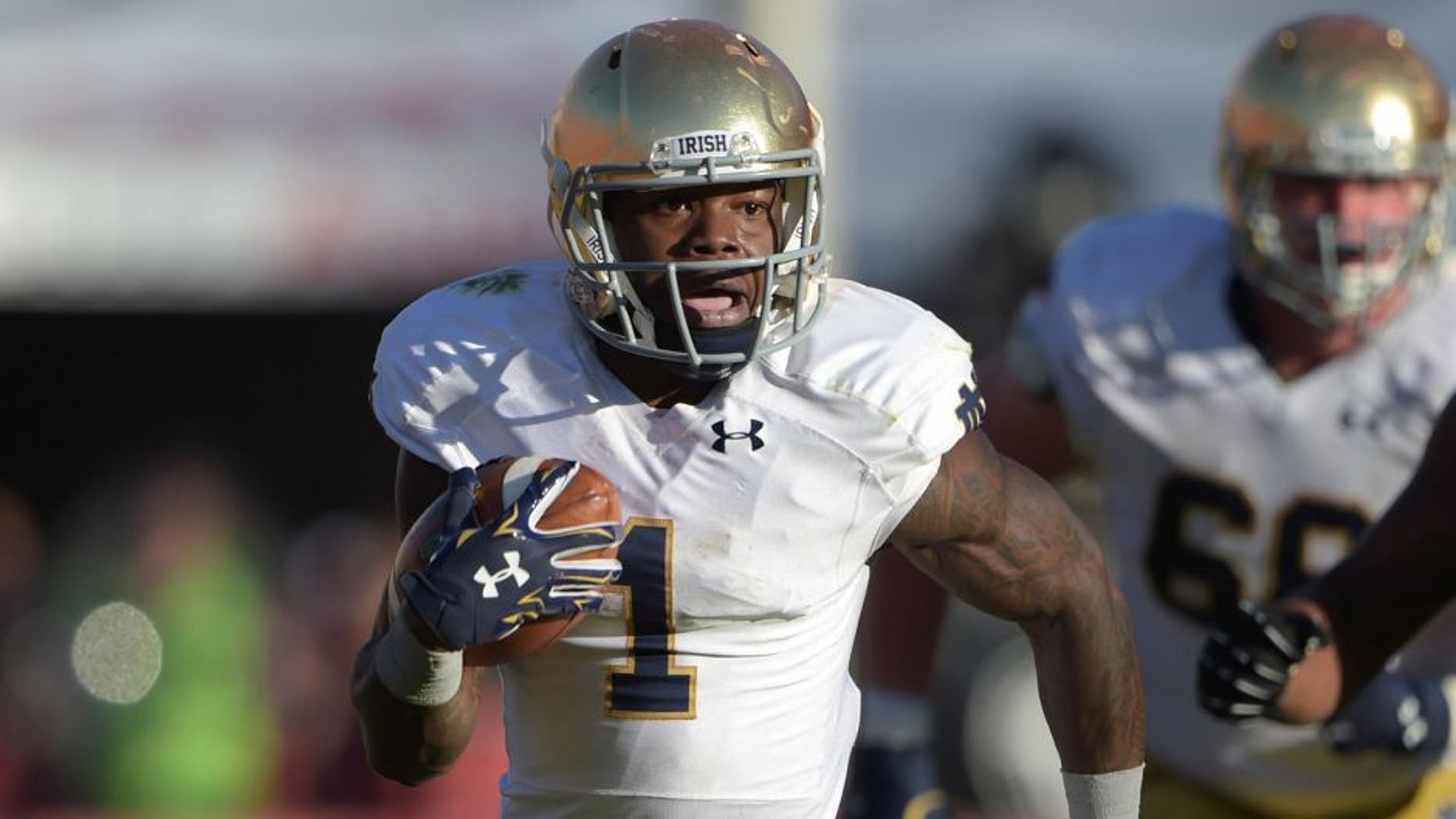 Nov 29, 2014; Los Angeles, CA, USA; Notre Dame Fighting Irish running back Greg Bryant (1) carries the ball against the Southern California Trojans at Los Angeles Memorial Coliseum. USC defeated Notre Dame 49-14. Mandatory Credit: Kirby Lee-USA TODAY Sports