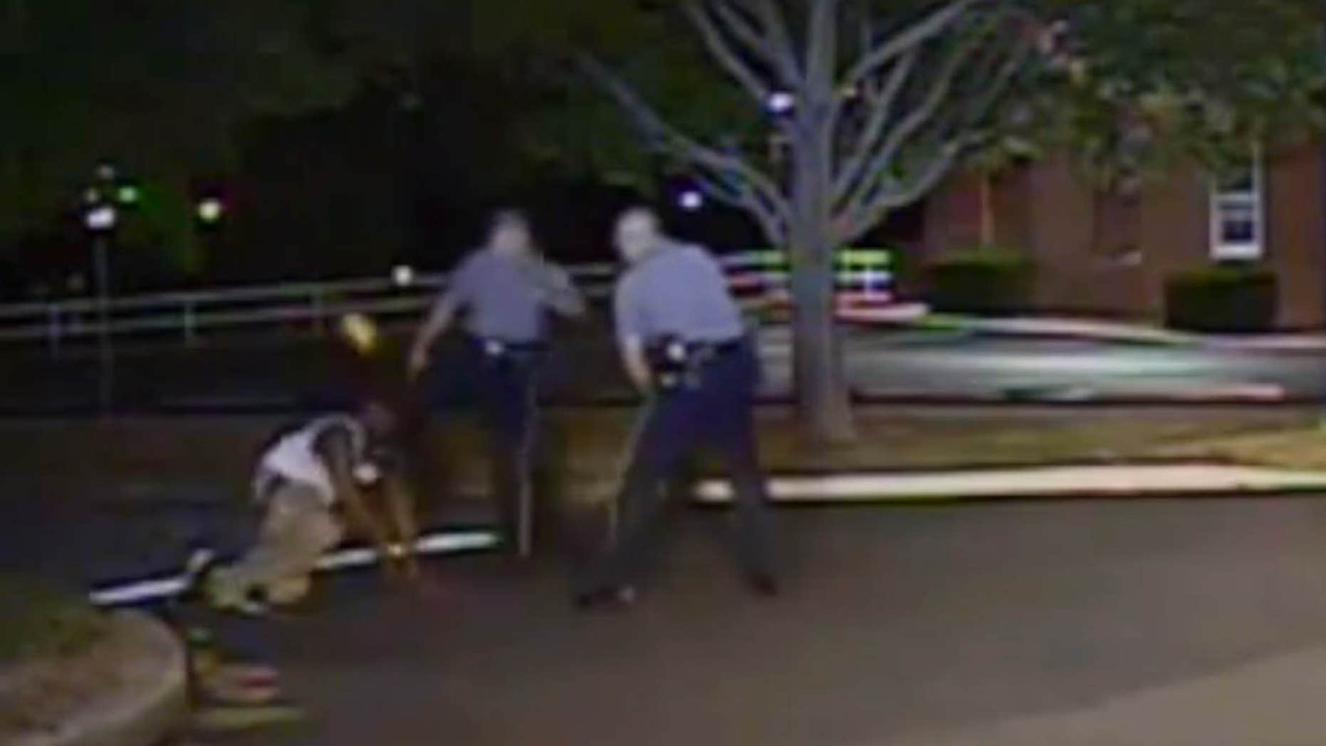 Aug. 24, 2013: In this photo made from a police dash camera video and released by the Dover Police Department, Dover Police Cpl. Thomas Webster, center, kicks Lateef Dickerson in the face as Dickerson is following orders to get on the ground during an arrest in Dover, Del.